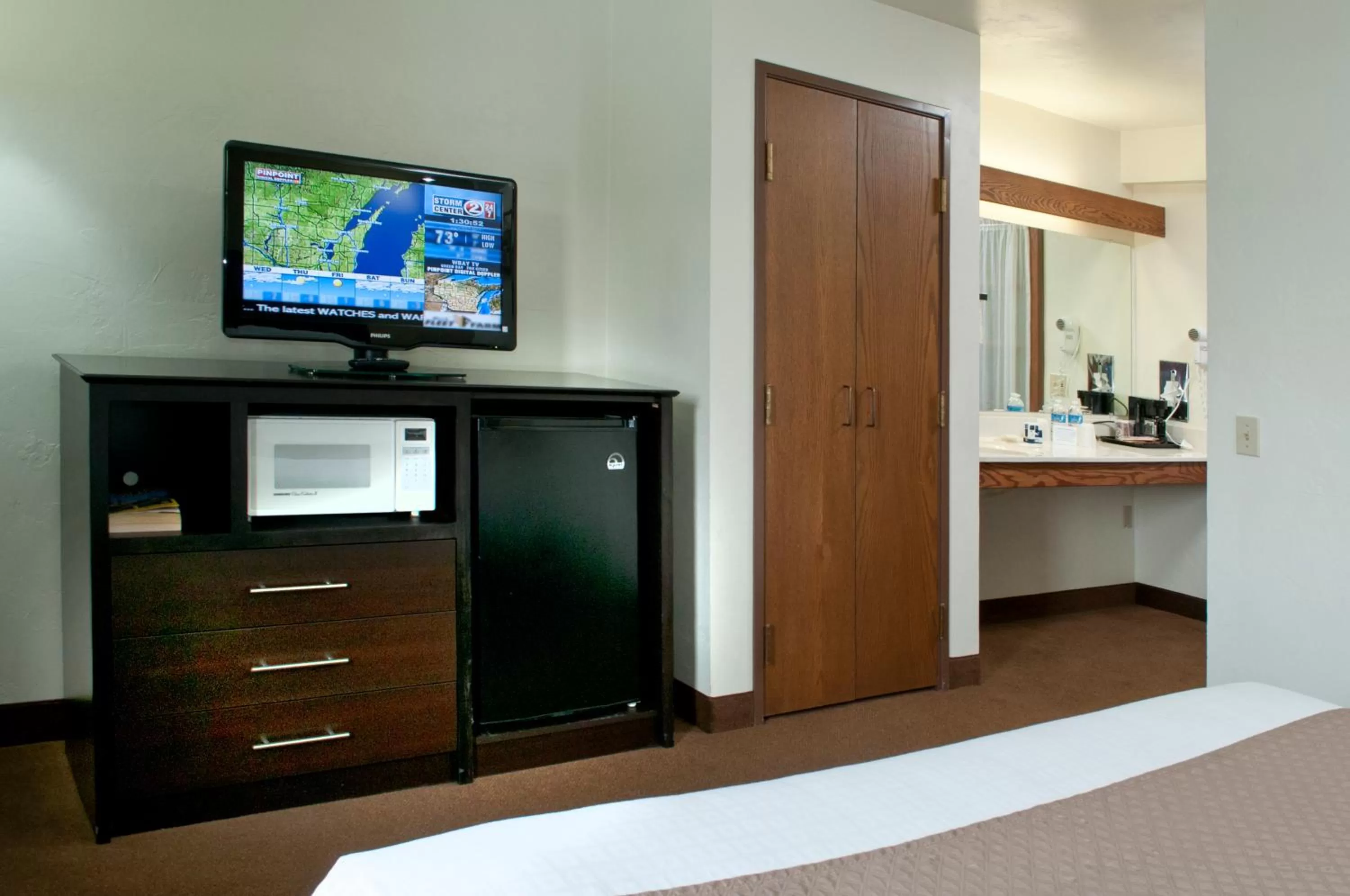 Decorative detail, Bed in AmericInn by Wyndham Green Bay West