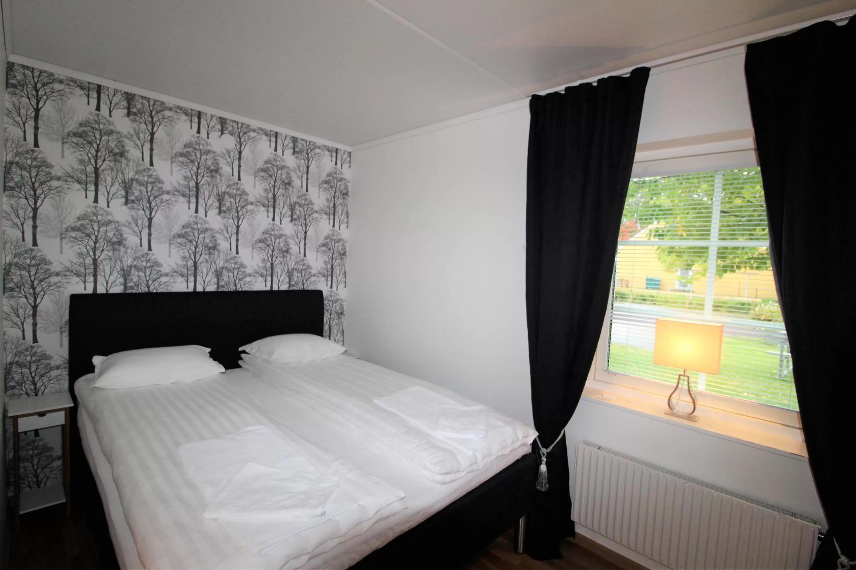 Bed in Easy Livin' Apartment Hotel