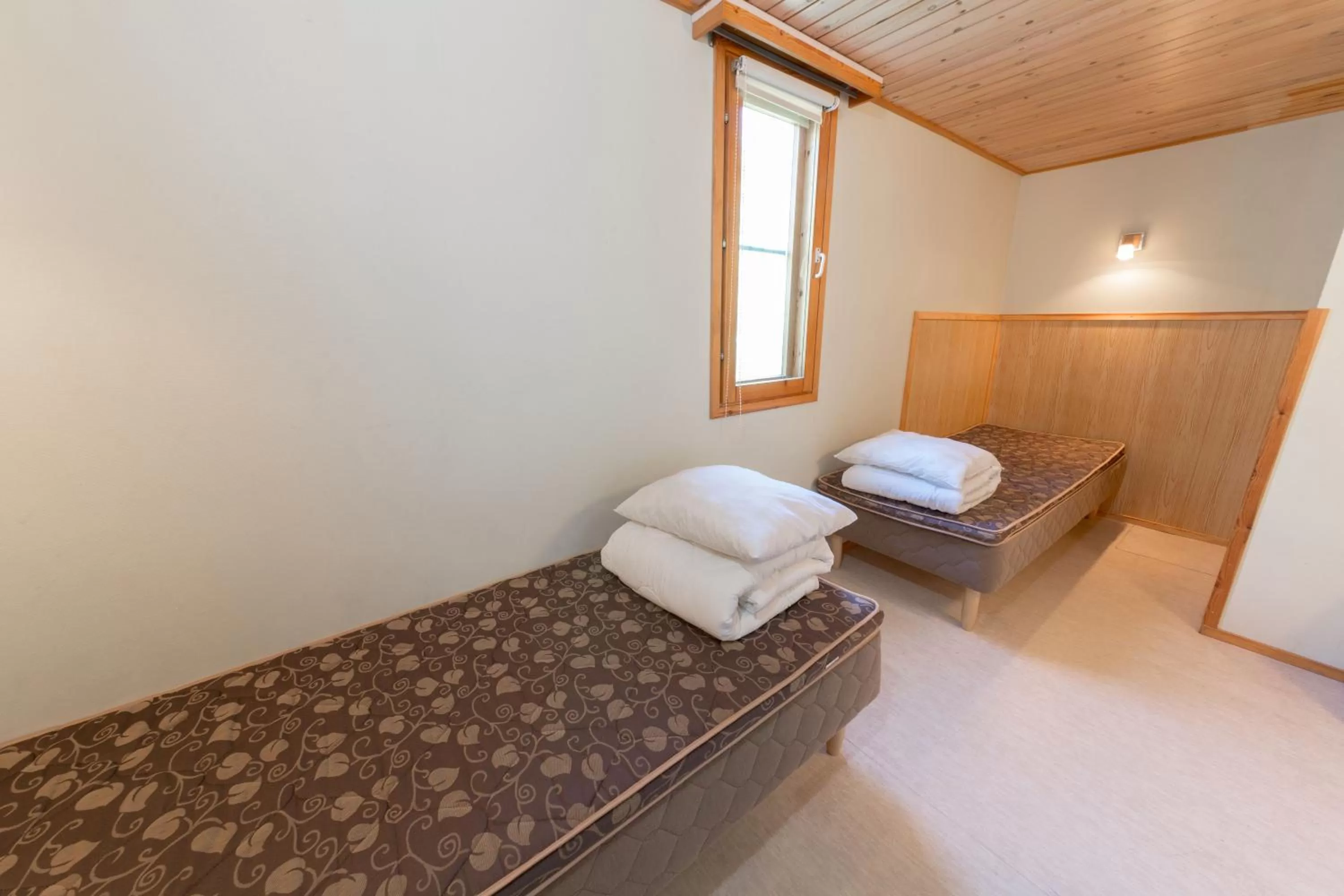 Bed in Yyteri Holiday Cottages