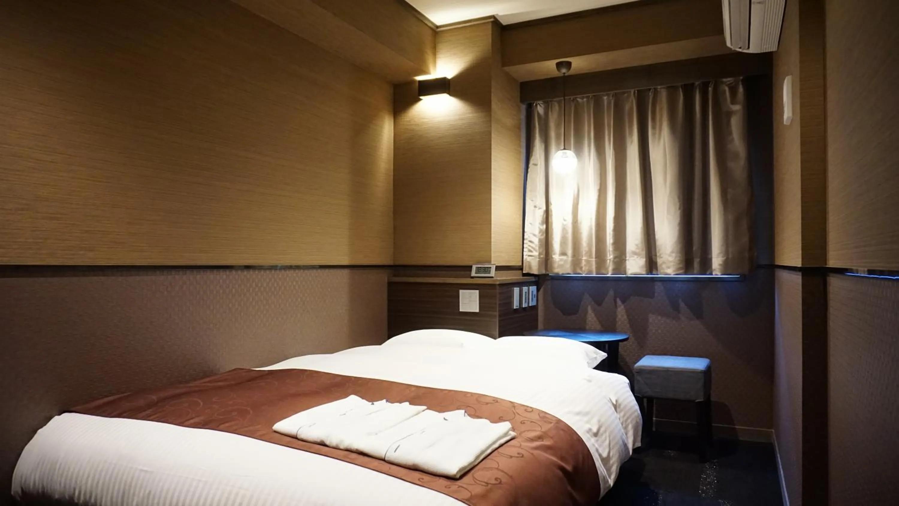 Bed in Hotel SUI Ginza Kyobashi by ABEST