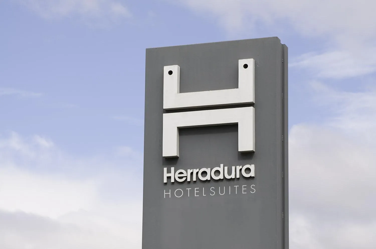 Property logo or sign in Herradura Hotel Suites