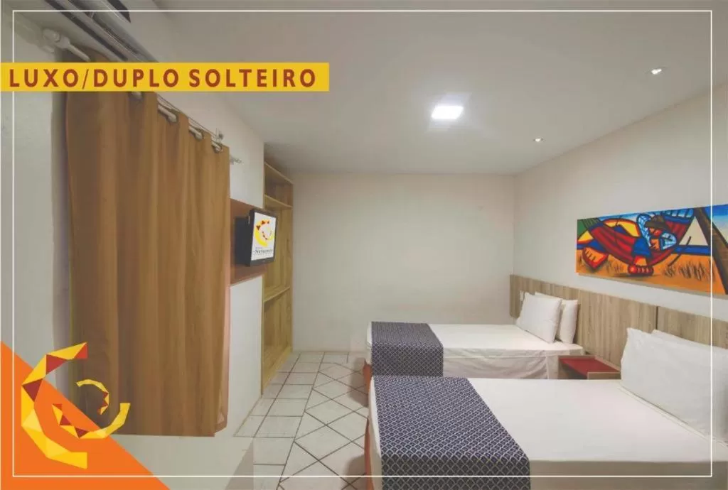 Bed in Netuanah Praia Hotel