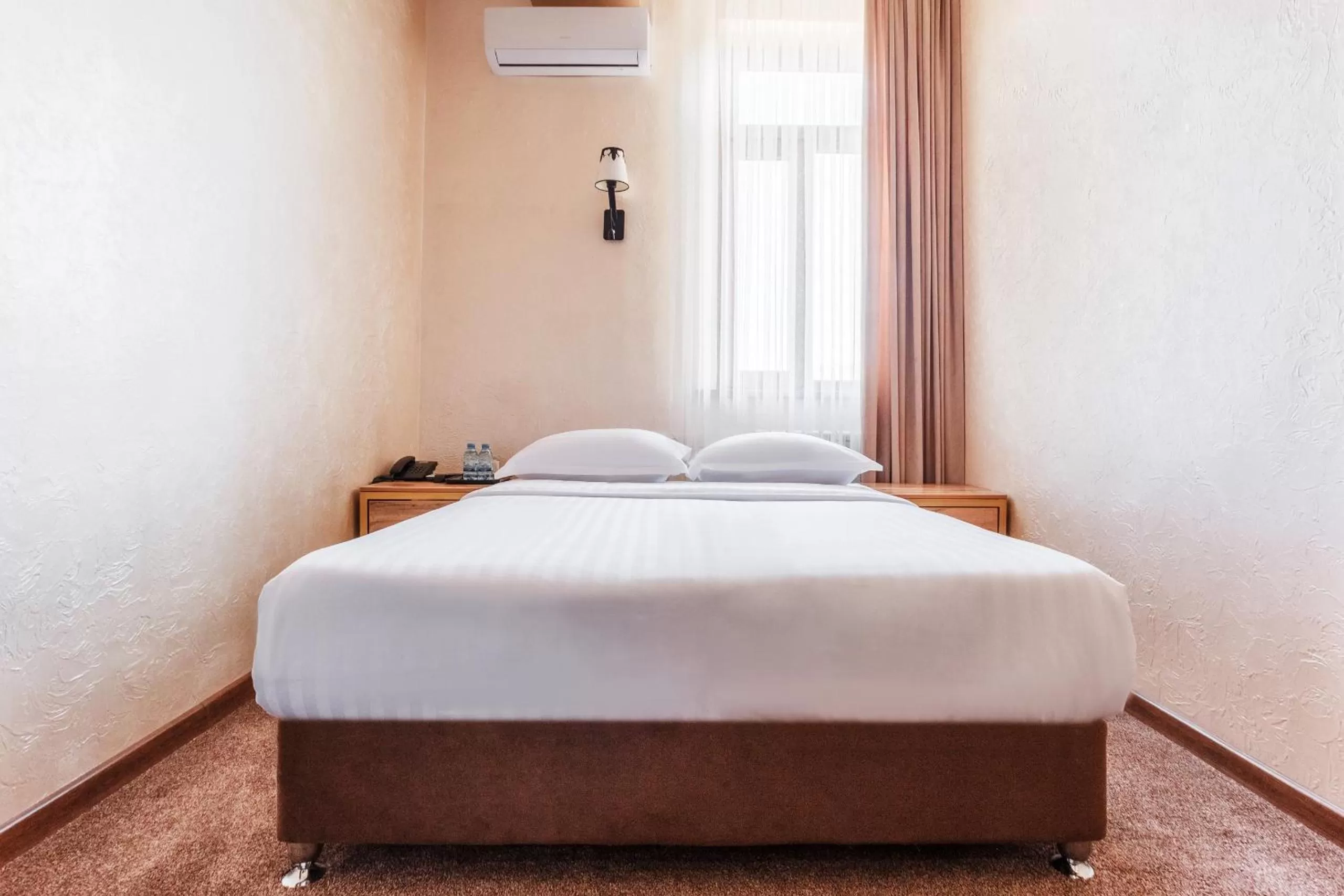 Bed in Western Suites Hotel