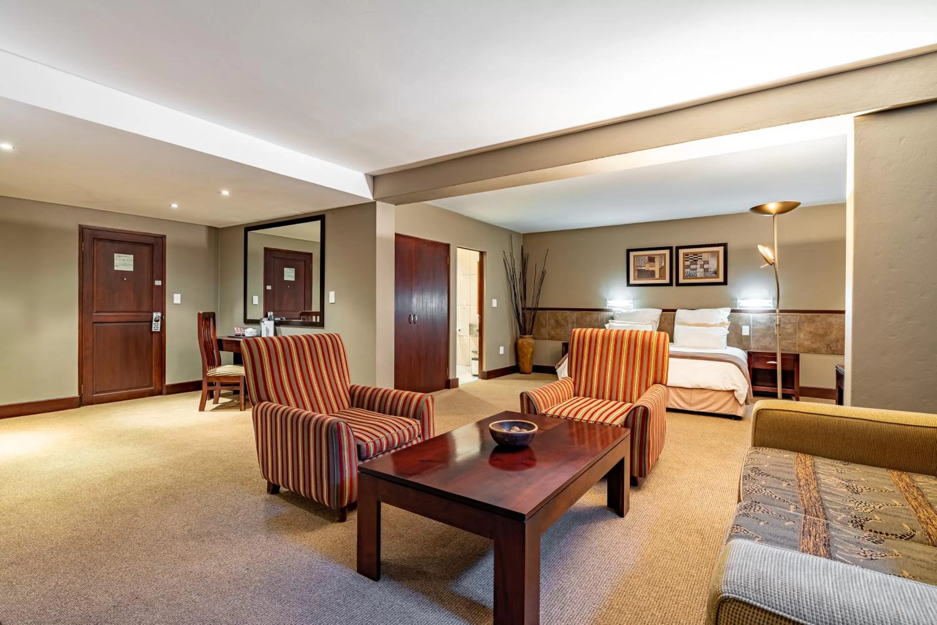 Seating area, Bed in African Sky Hotels - Pine Lake Inn
