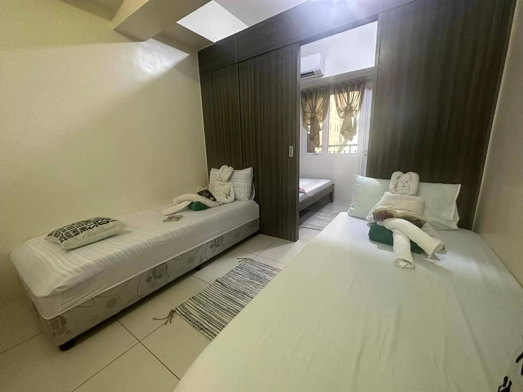 Bed in Green Residences Stays by PBYY