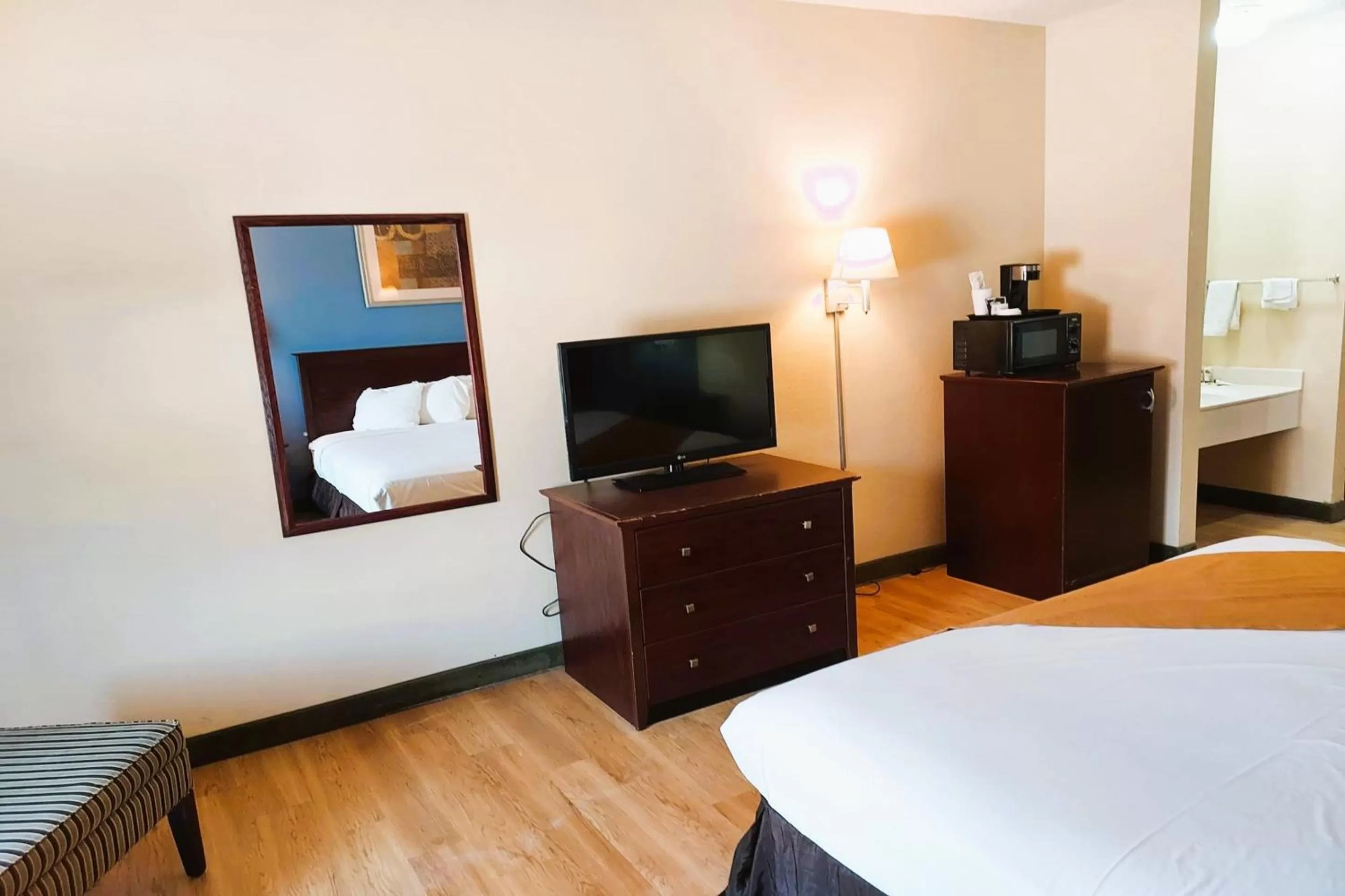 Bedroom, TV/Entertainment Center in McPherson Inn By OYO, I-135