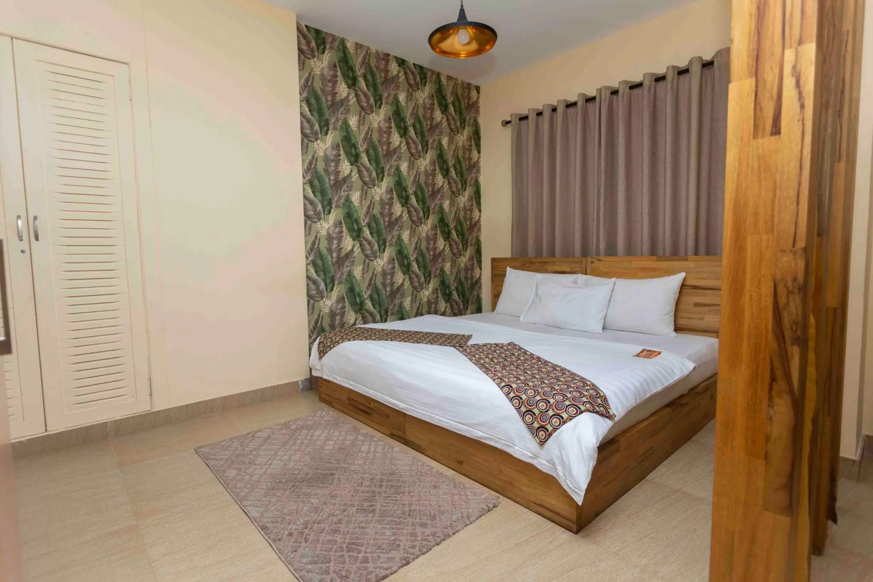 Bed in Roots Hotel Apartment