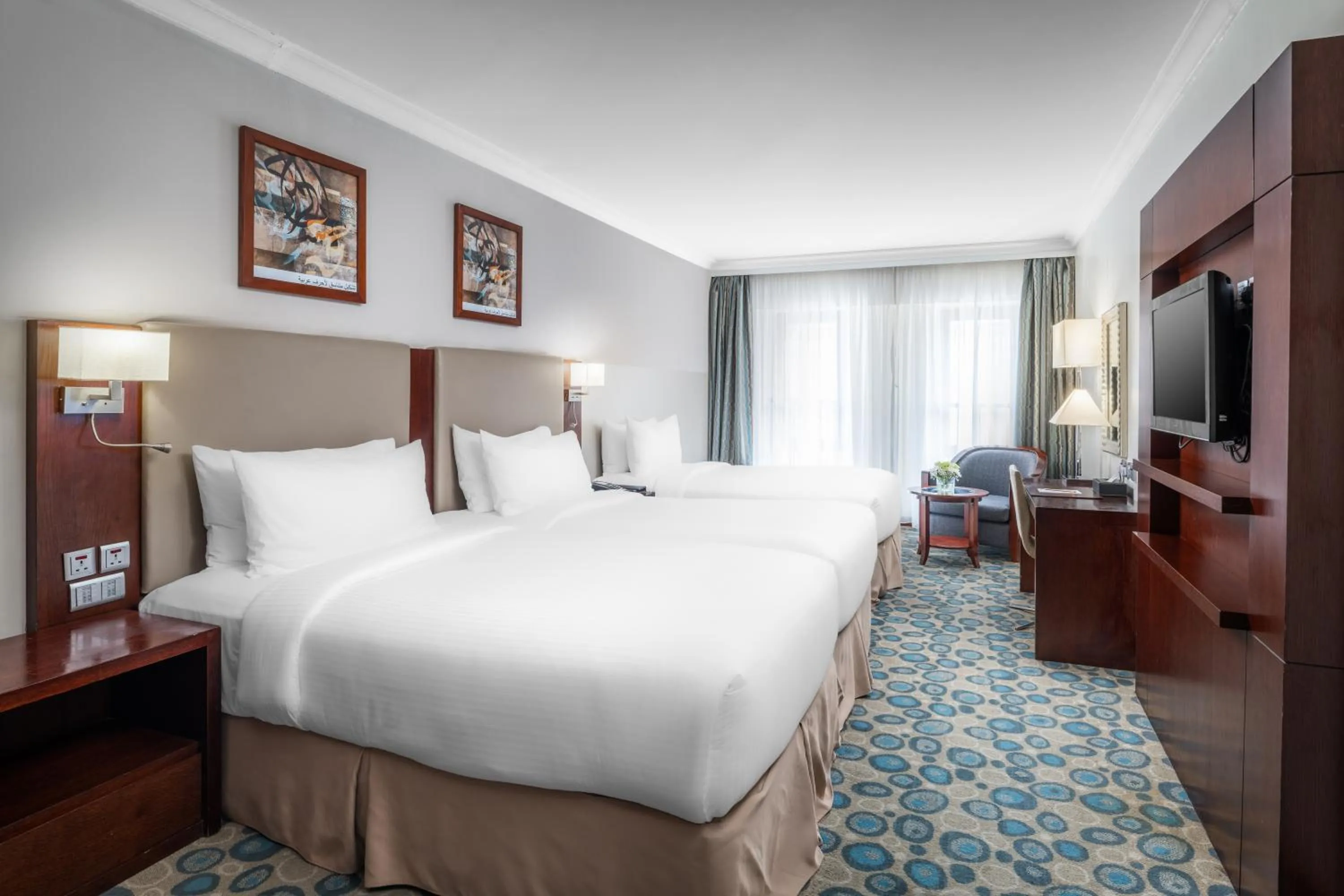 Bed in Millennium Al Aqeeq Hotel