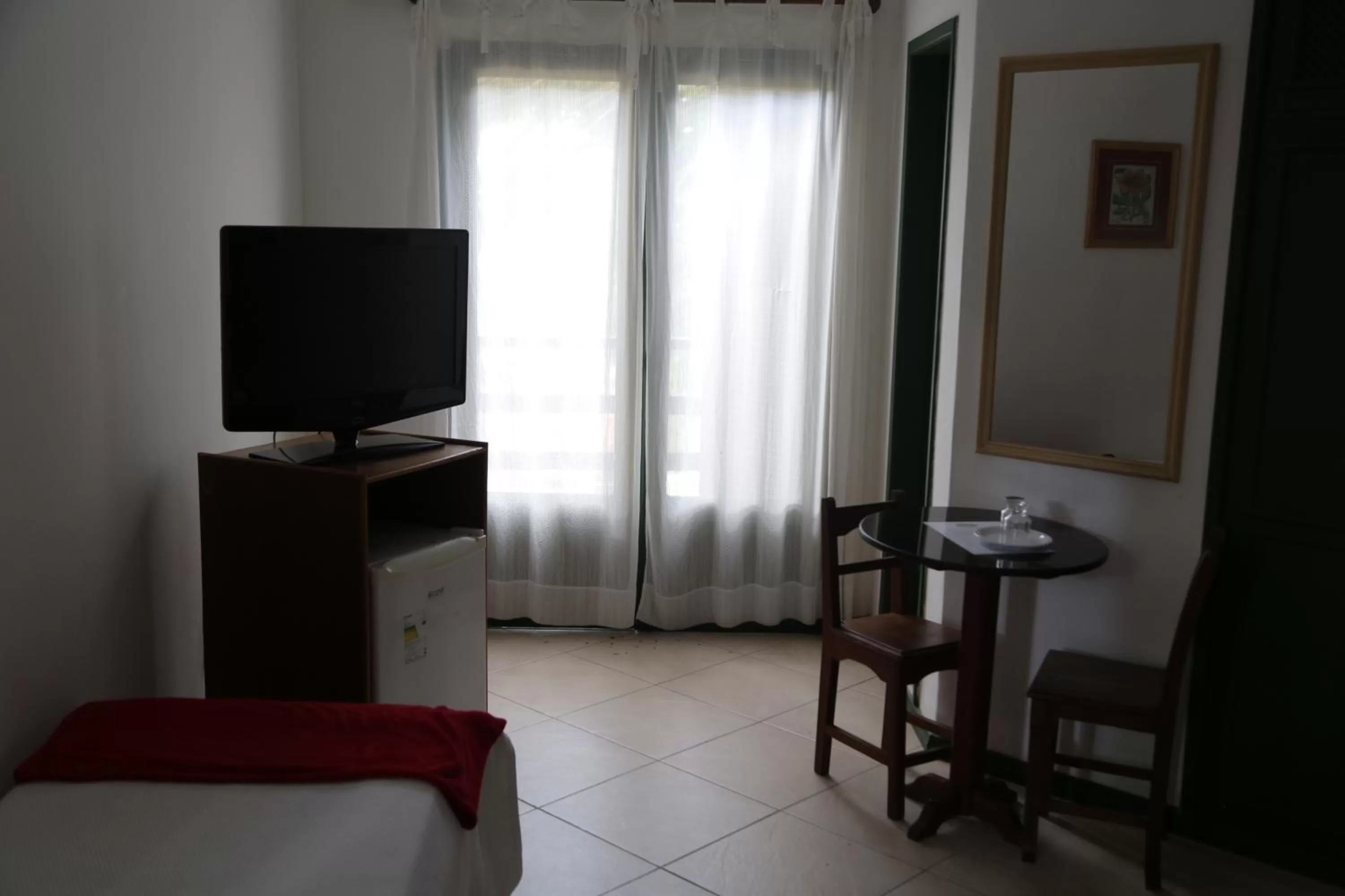 Communal lounge/ TV room, Bed in Pousada Saint Germain