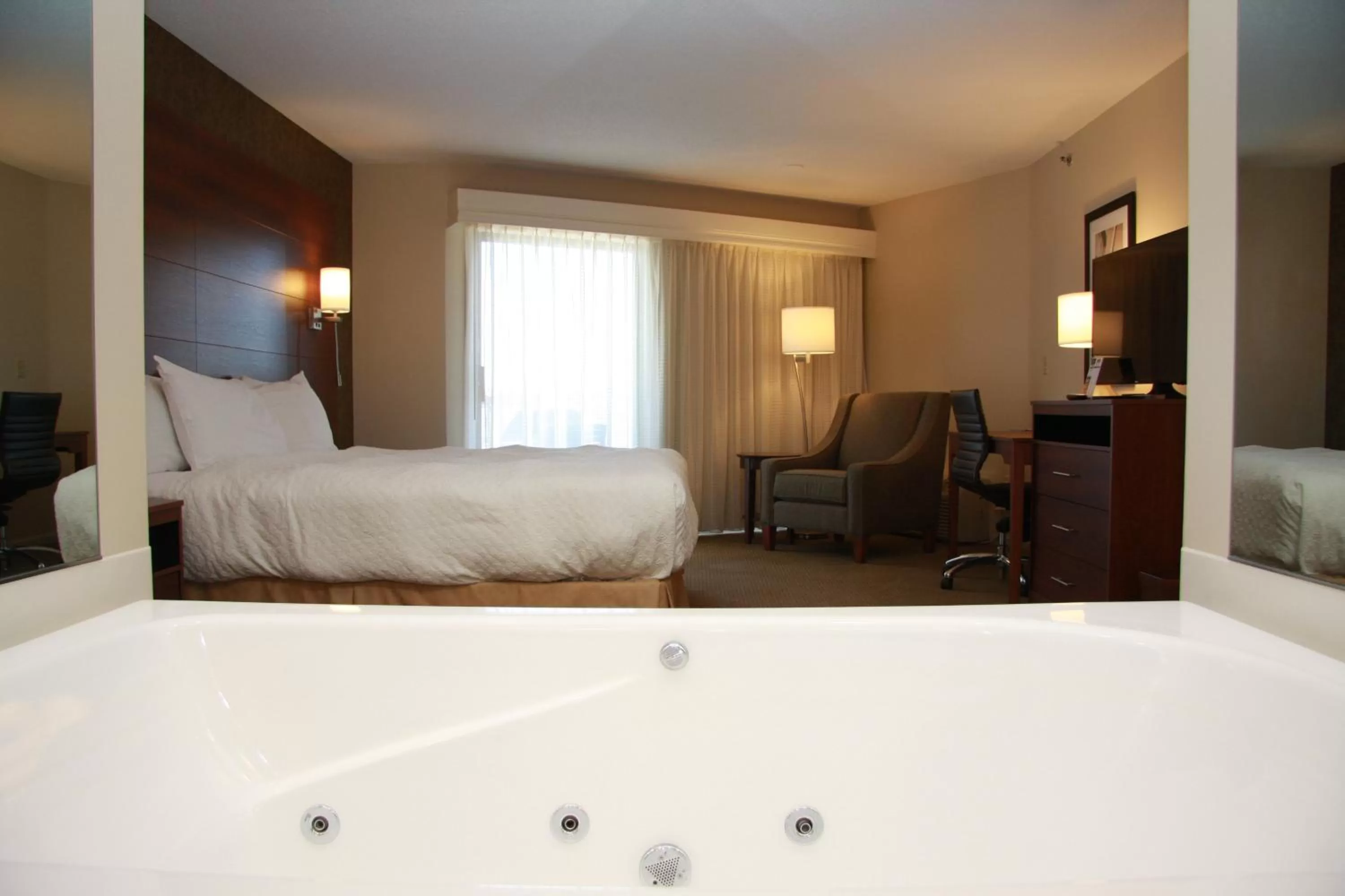 Bed in Budget Host Inn & Suites