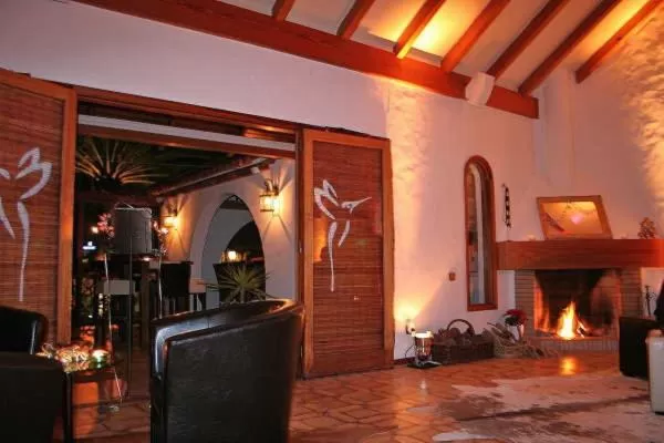 Communal lounge/ TV room in Birdcage Gay Men Resort and Lifestyle Hotel