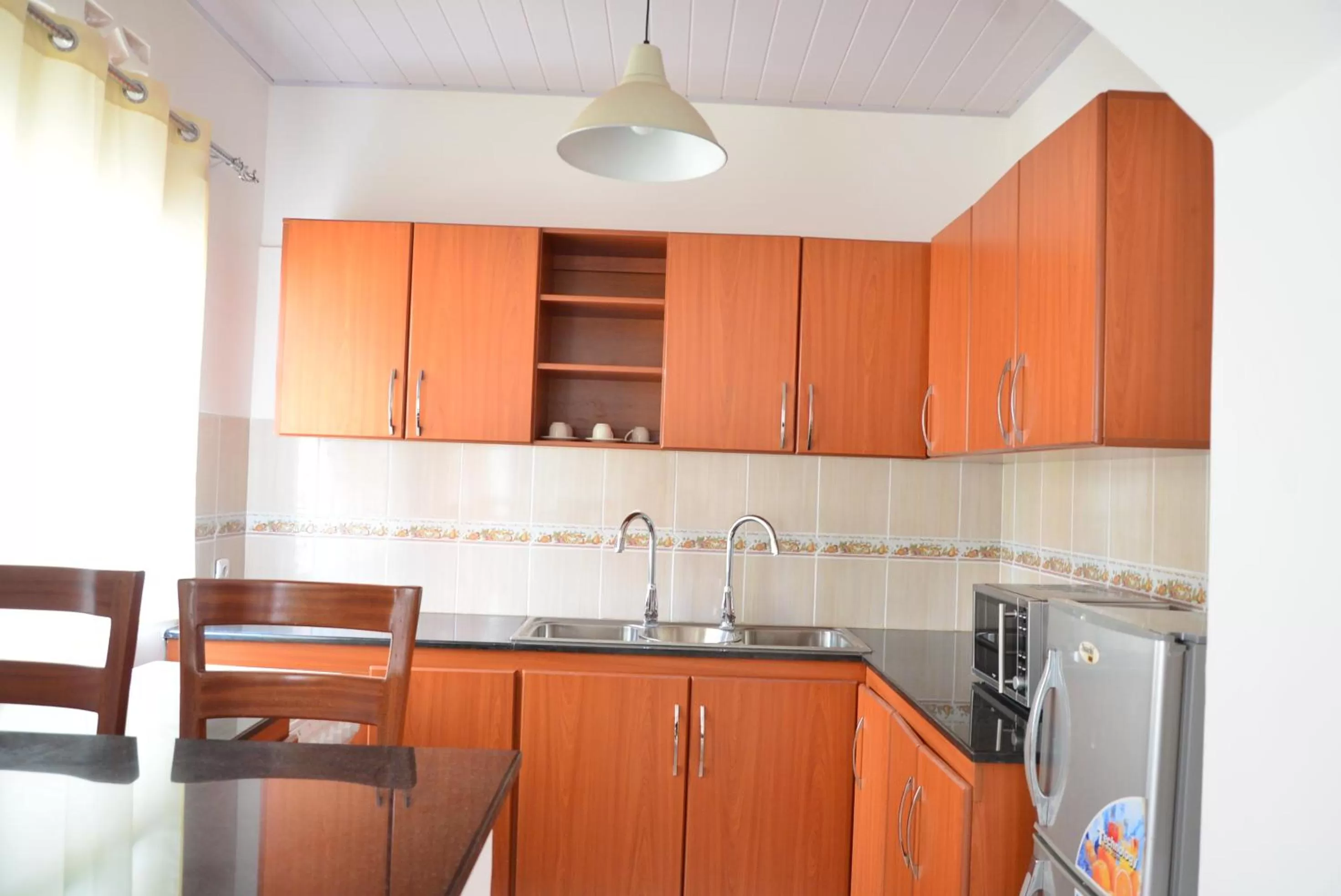 Kitchen or kitchenette in Hôtel Maisons-Sifa