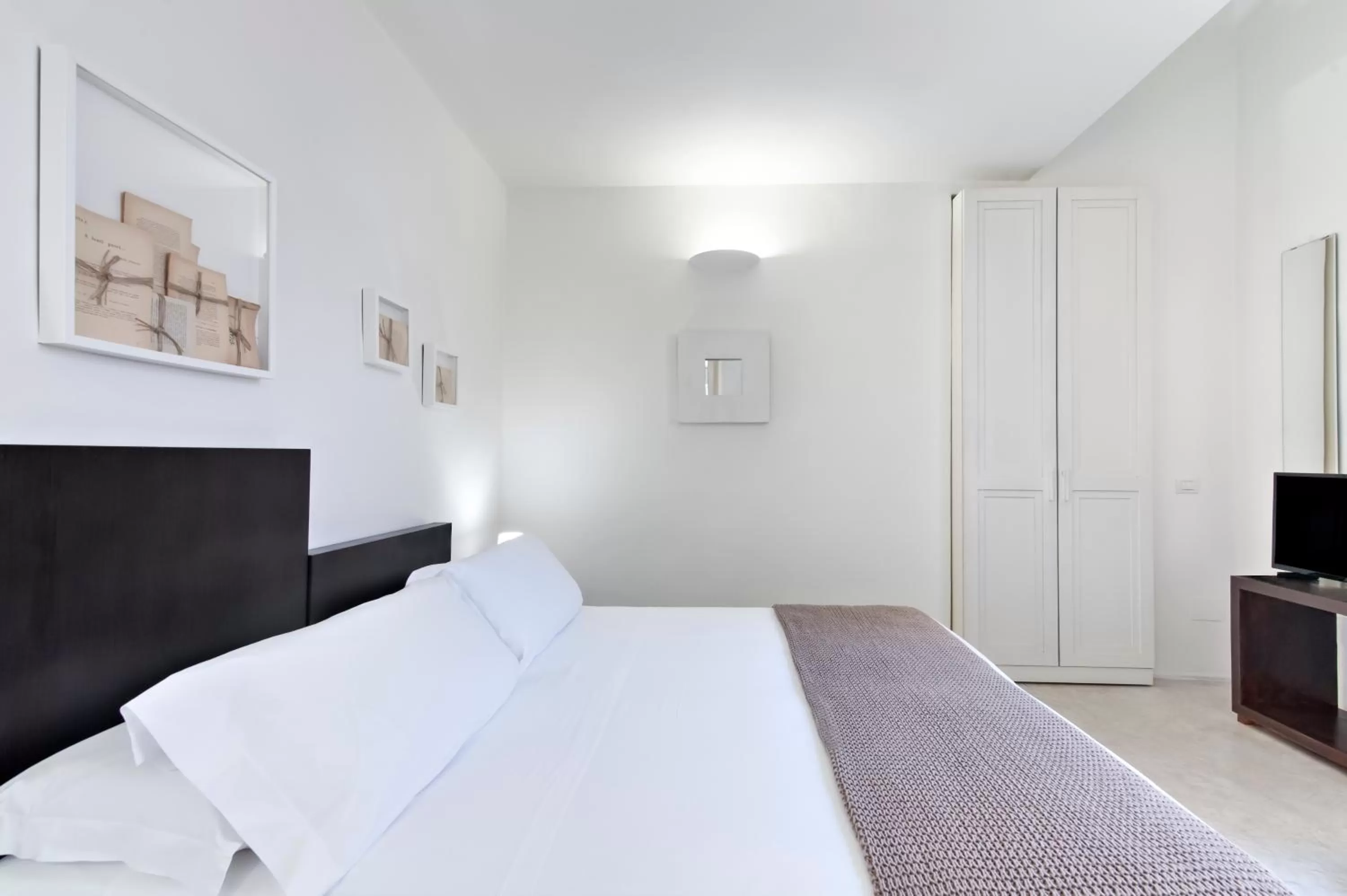 Bed in Casa di Lo Suites