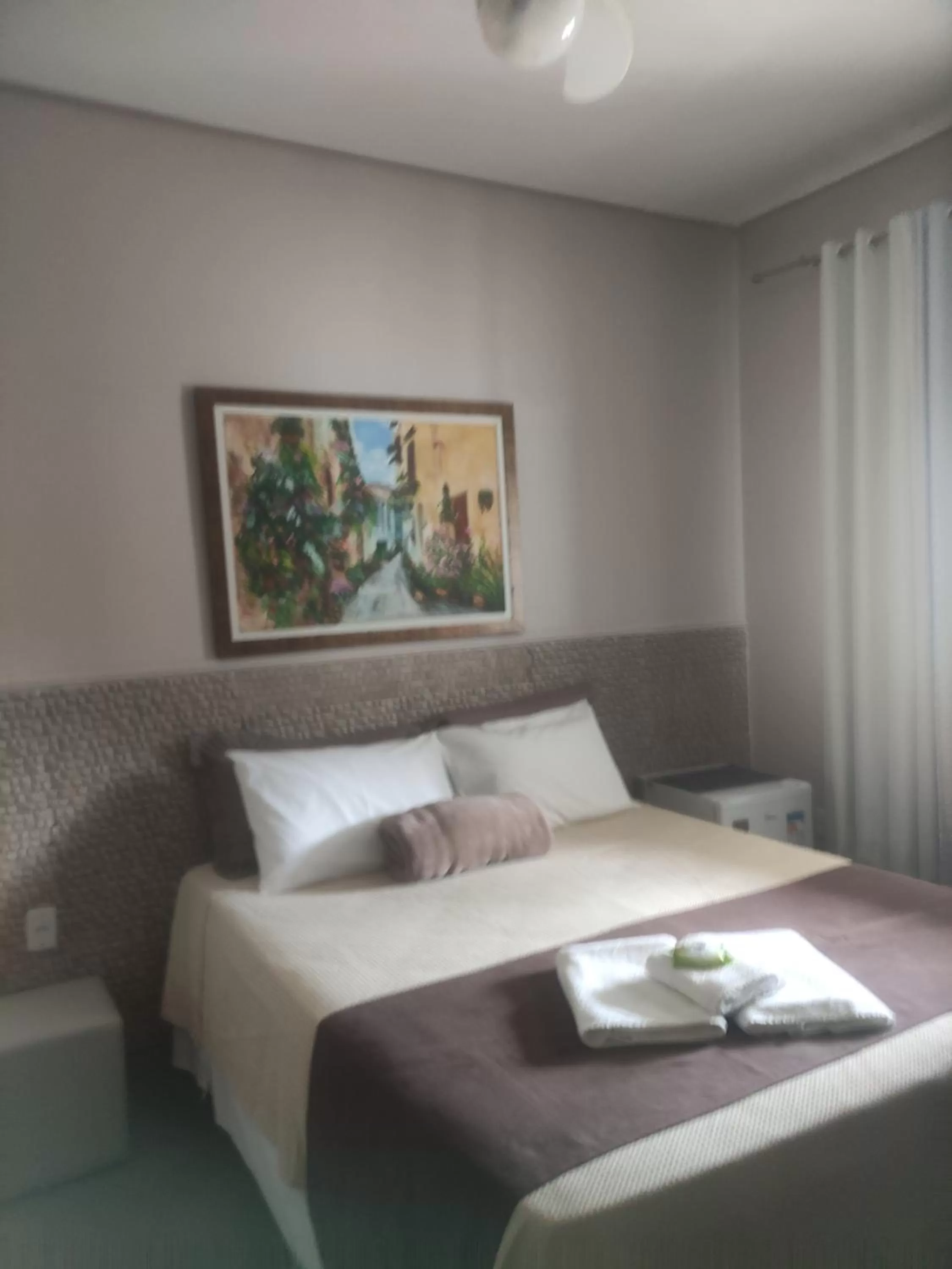 Bed in Pousada da Gi Suítes e Turismo