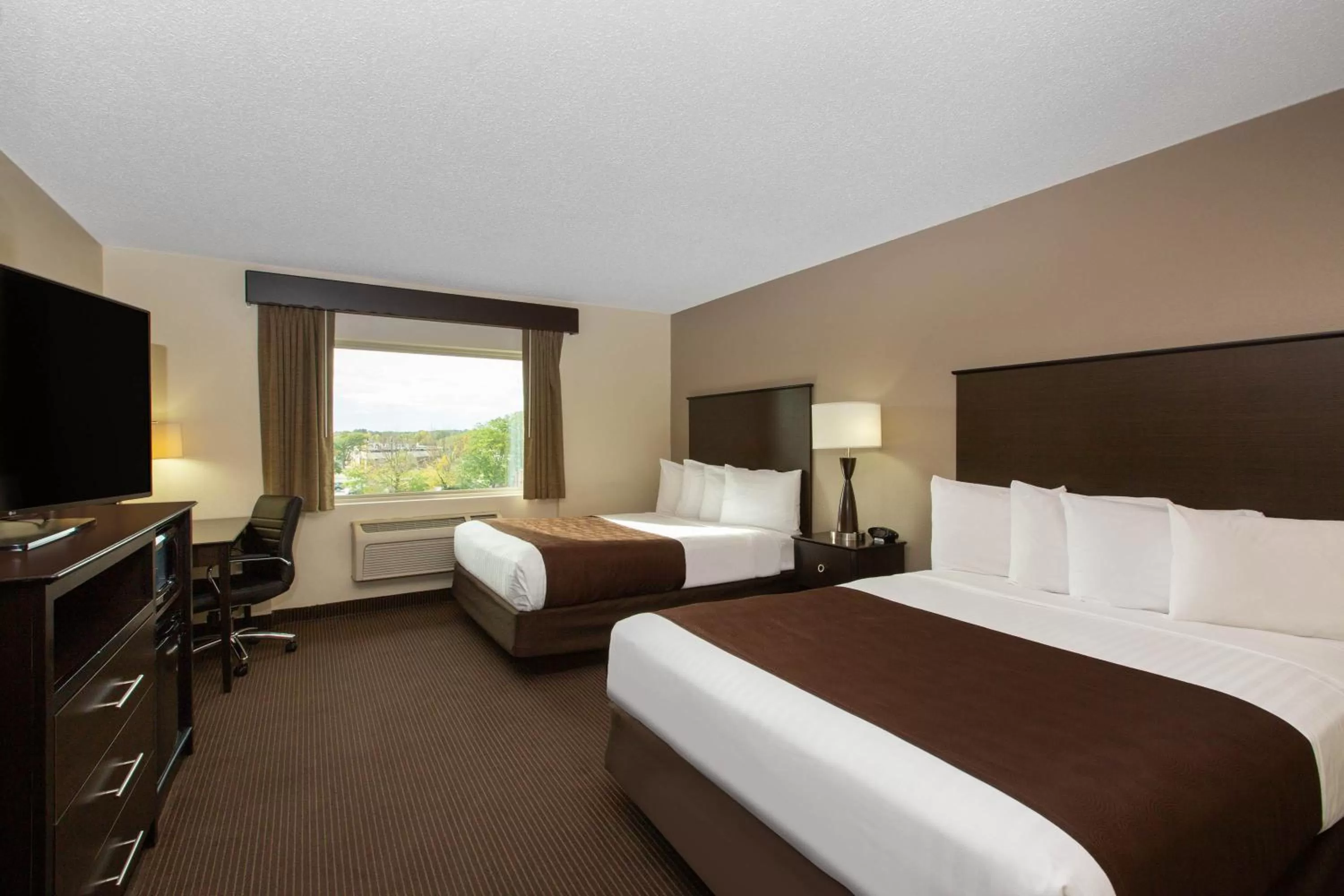 Bed in AmericInn by Wyndham Apple Valley