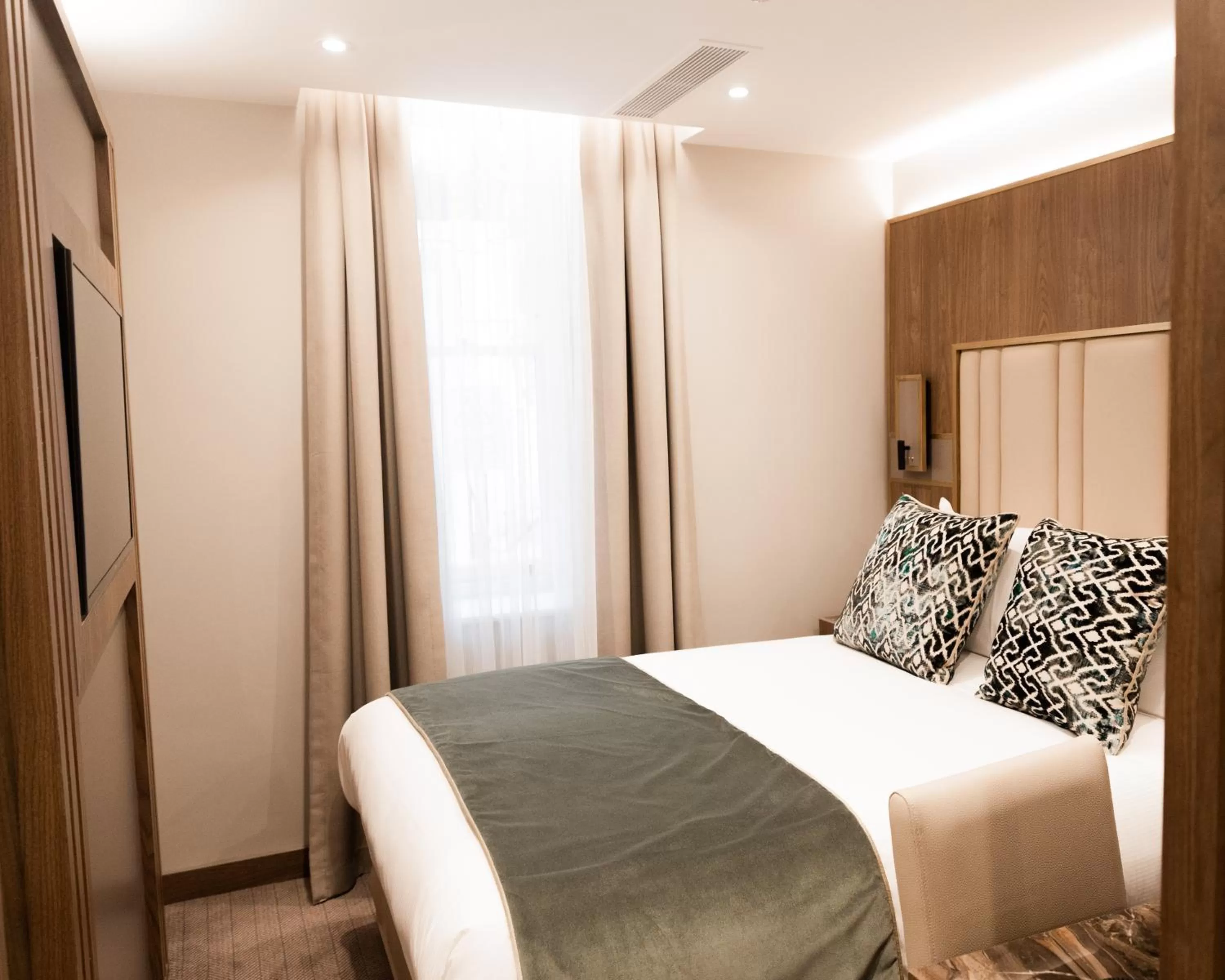 Bed in Merit Kensington Hotel