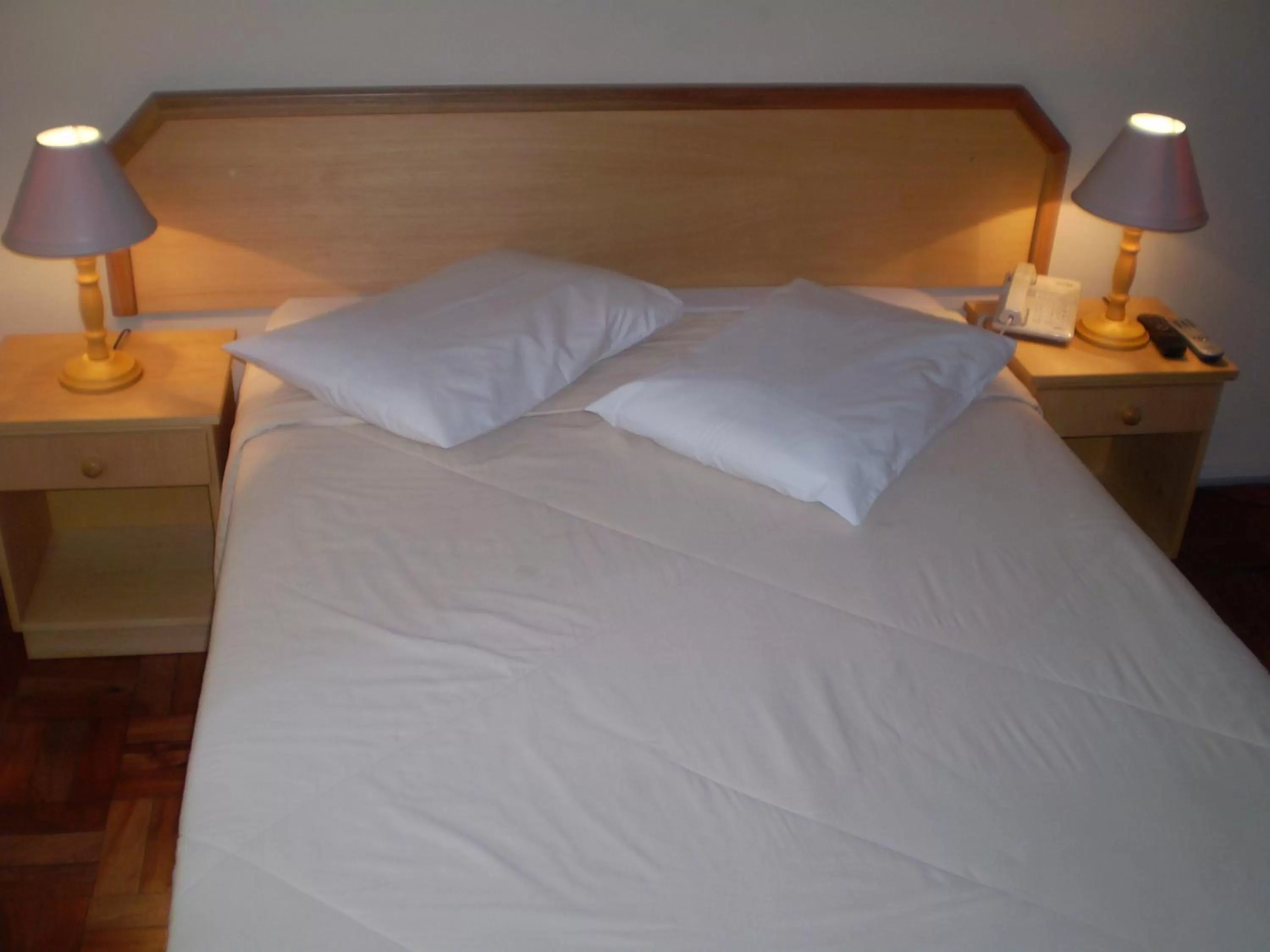 Bed in Hotel Gravataí Center