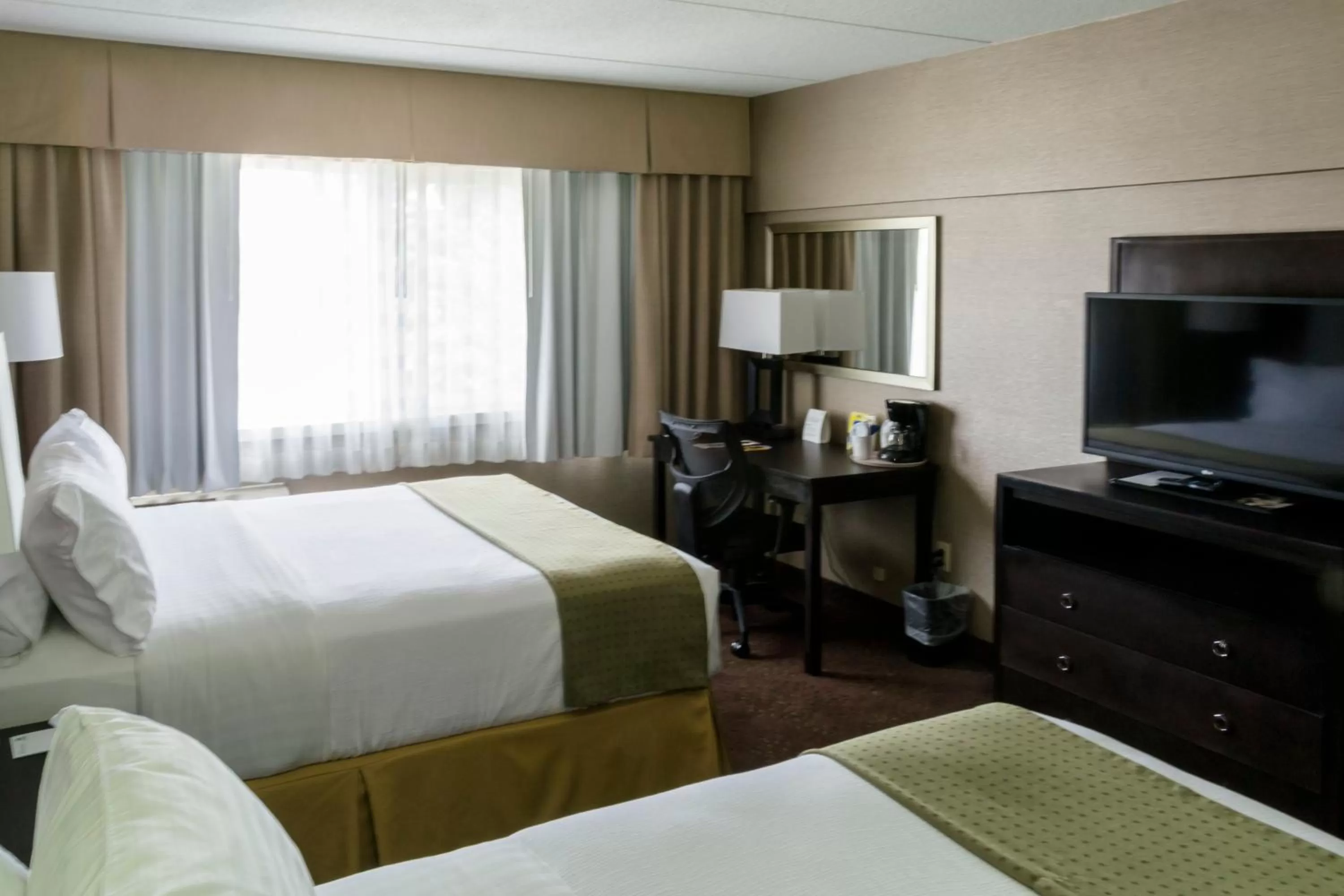 Standard Queen Room with Two Queen Beds and Mobility Accessible Roll-In Shower in Holiday Inn Express Big Rapids, an IHG Hotel