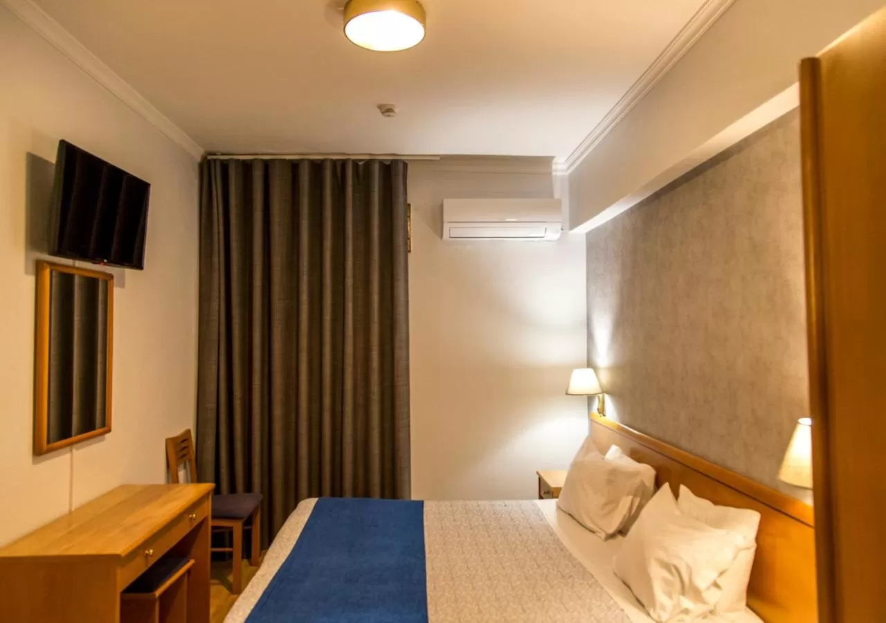 Communal lounge/ TV room, Bed in Hotel Columbano