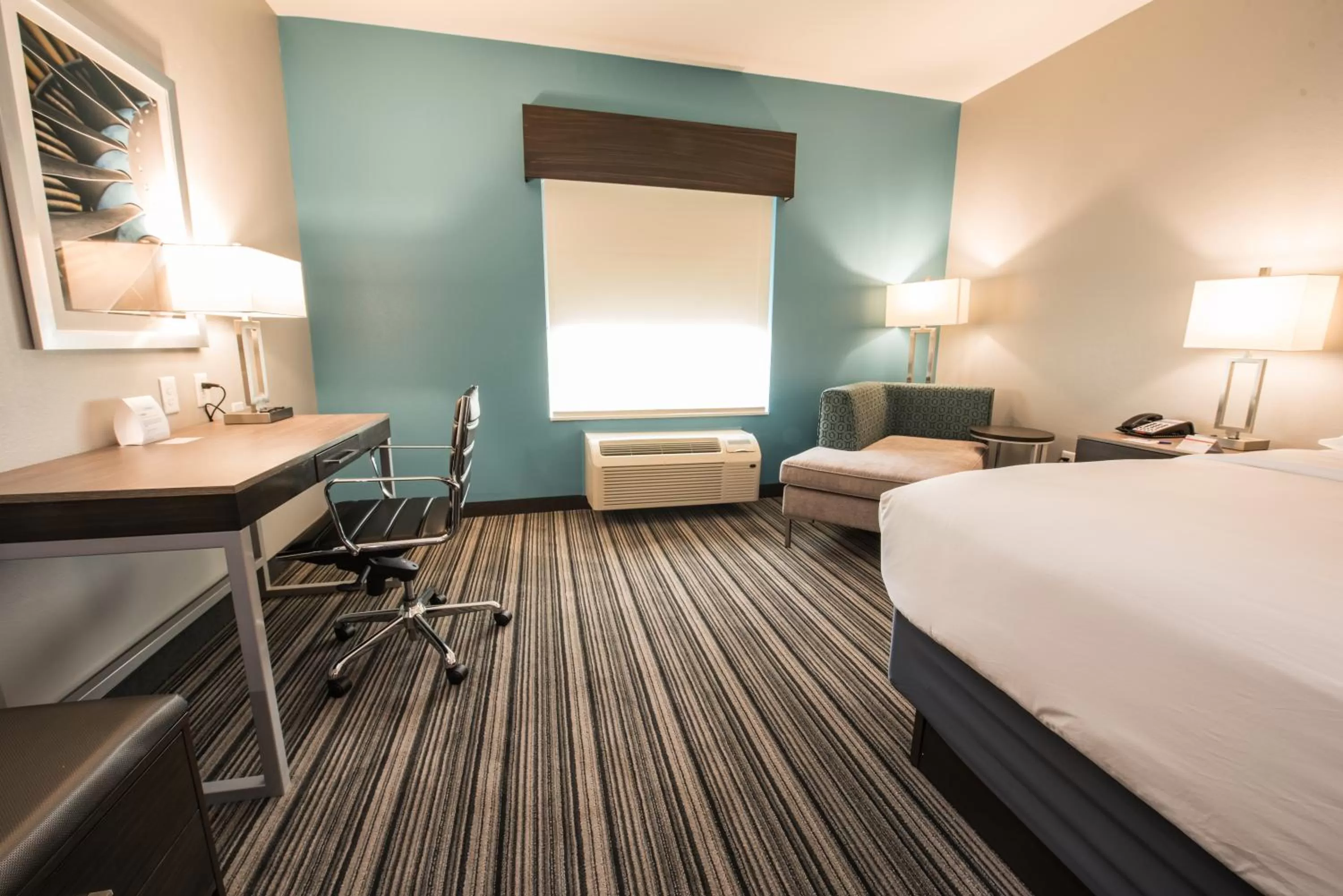 Seating area, Bed in Holiday Inn Express & Suites Houston - Hobby Airport Area by IHG