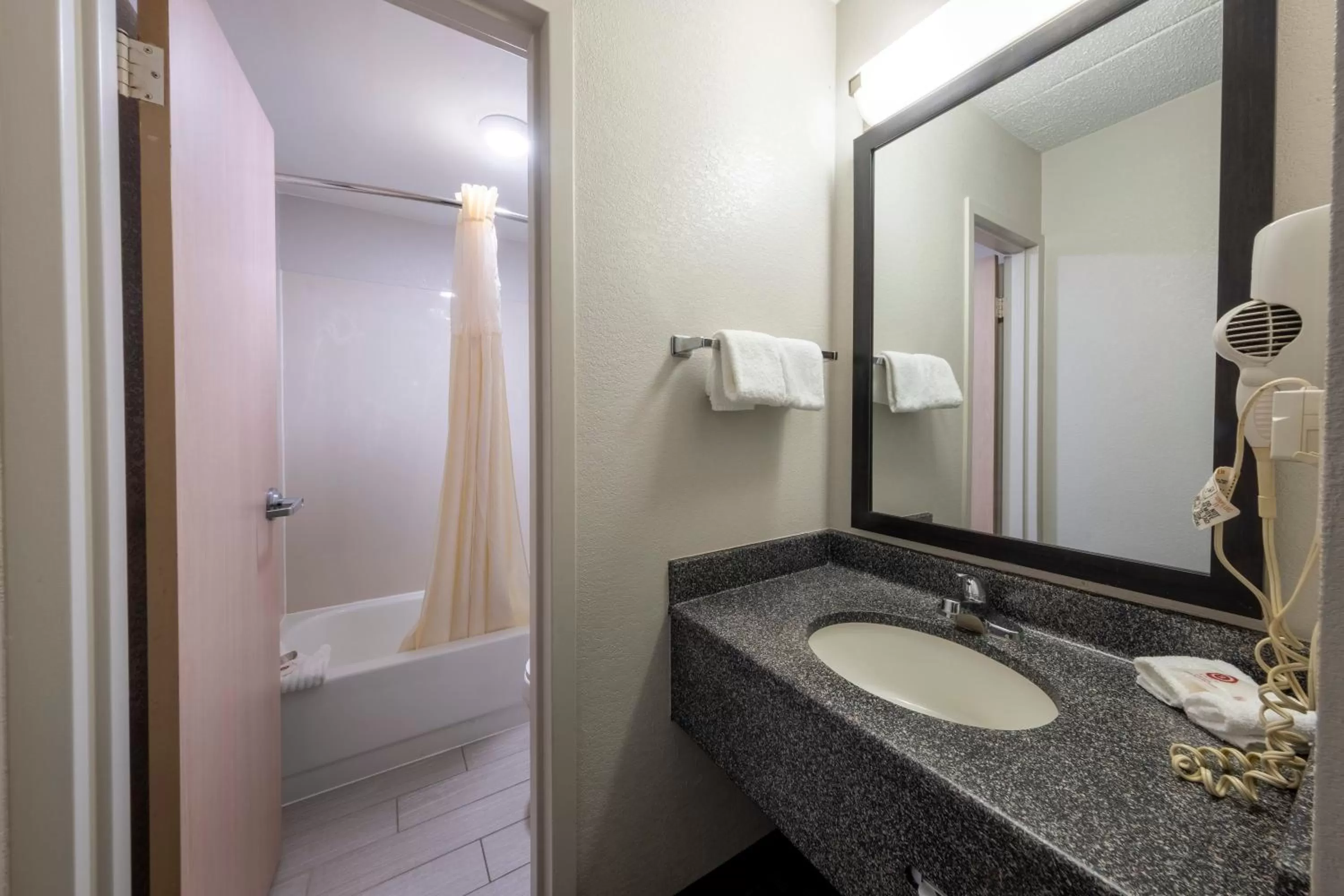 Bathroom in HomeTown Inn by Red Roof East Syracuse