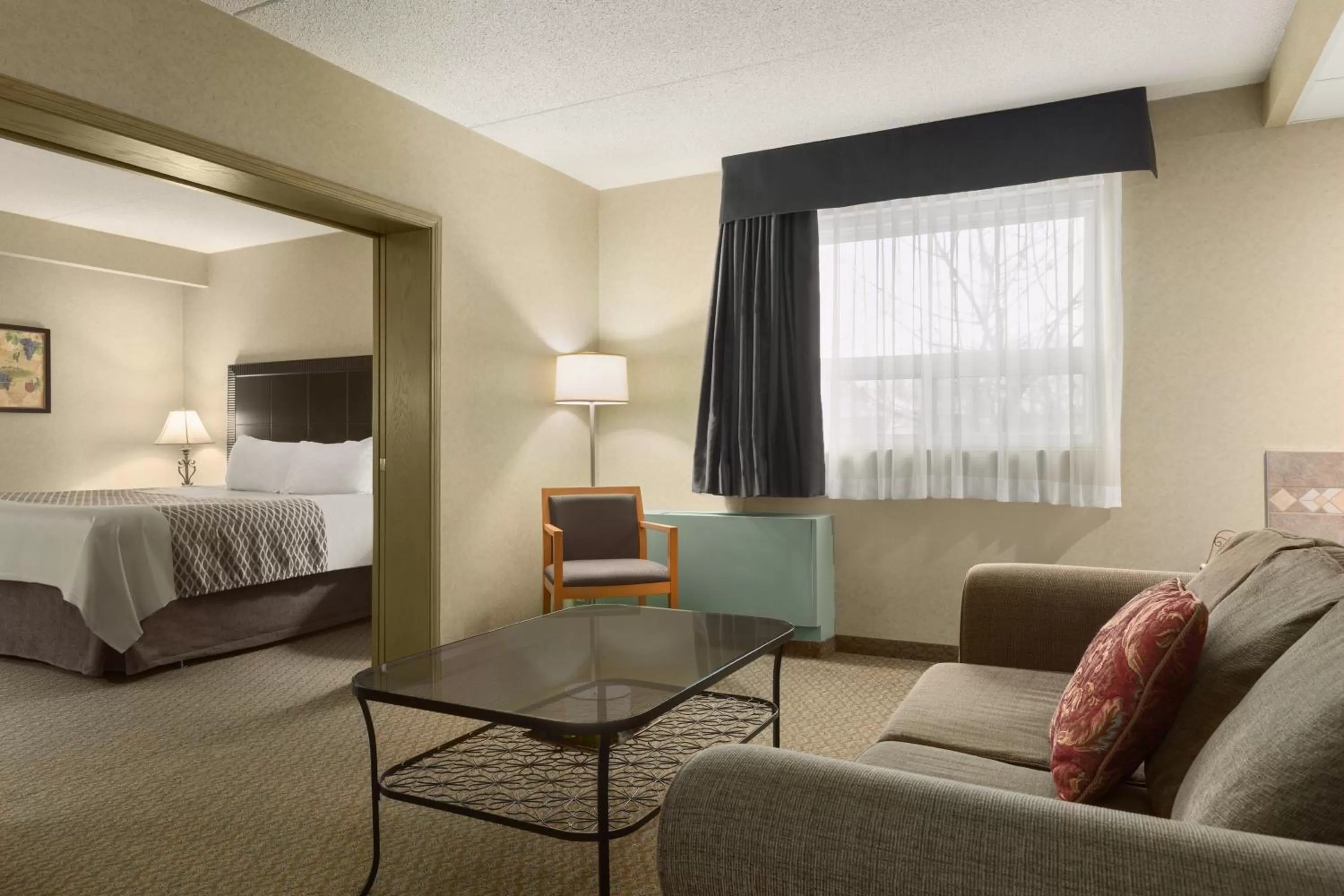 Seating area, Bed in Travelodge by Wyndham Winnipeg East