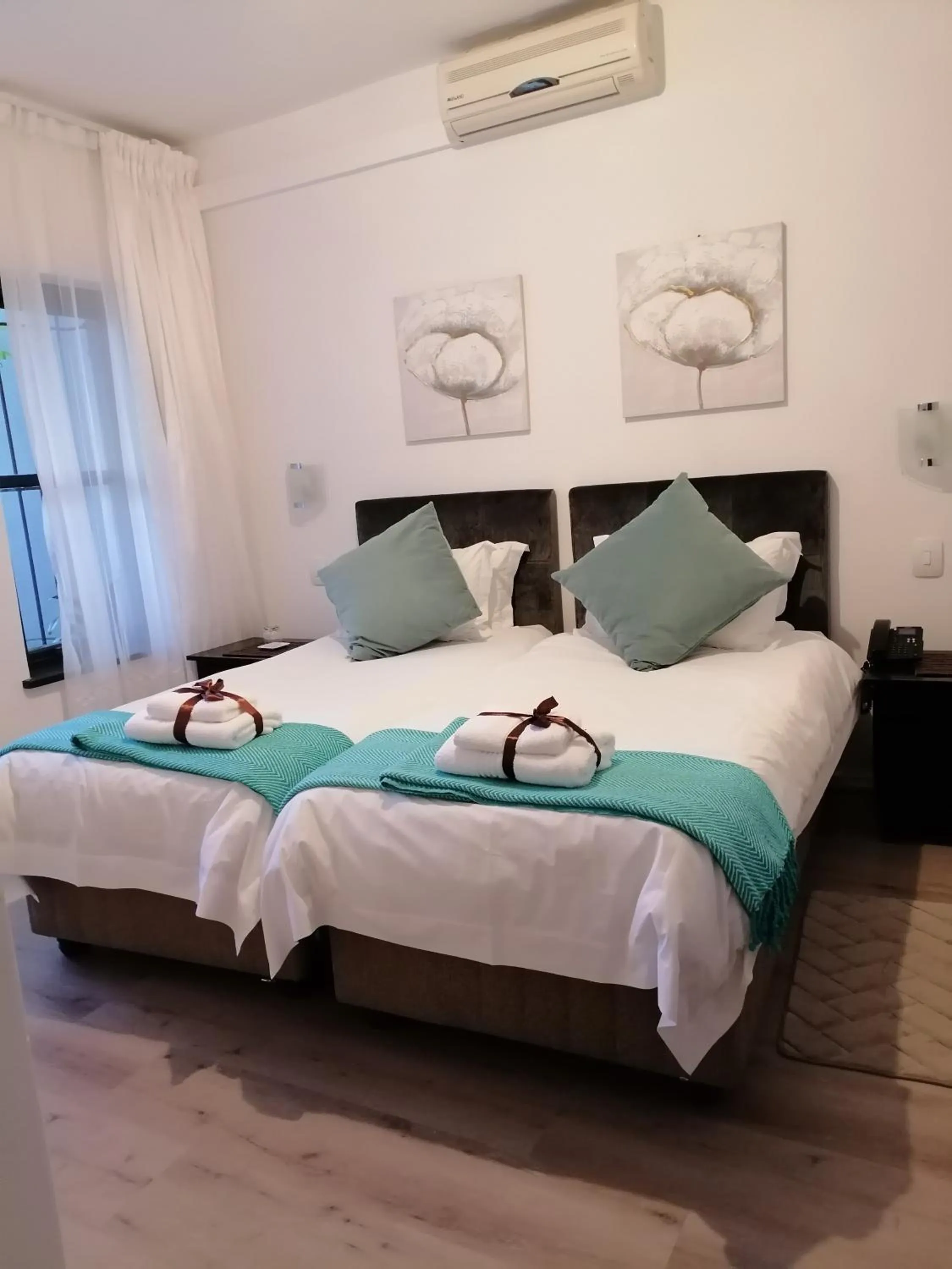 Bed in Point B Guest House -Sustainable Solar Energy