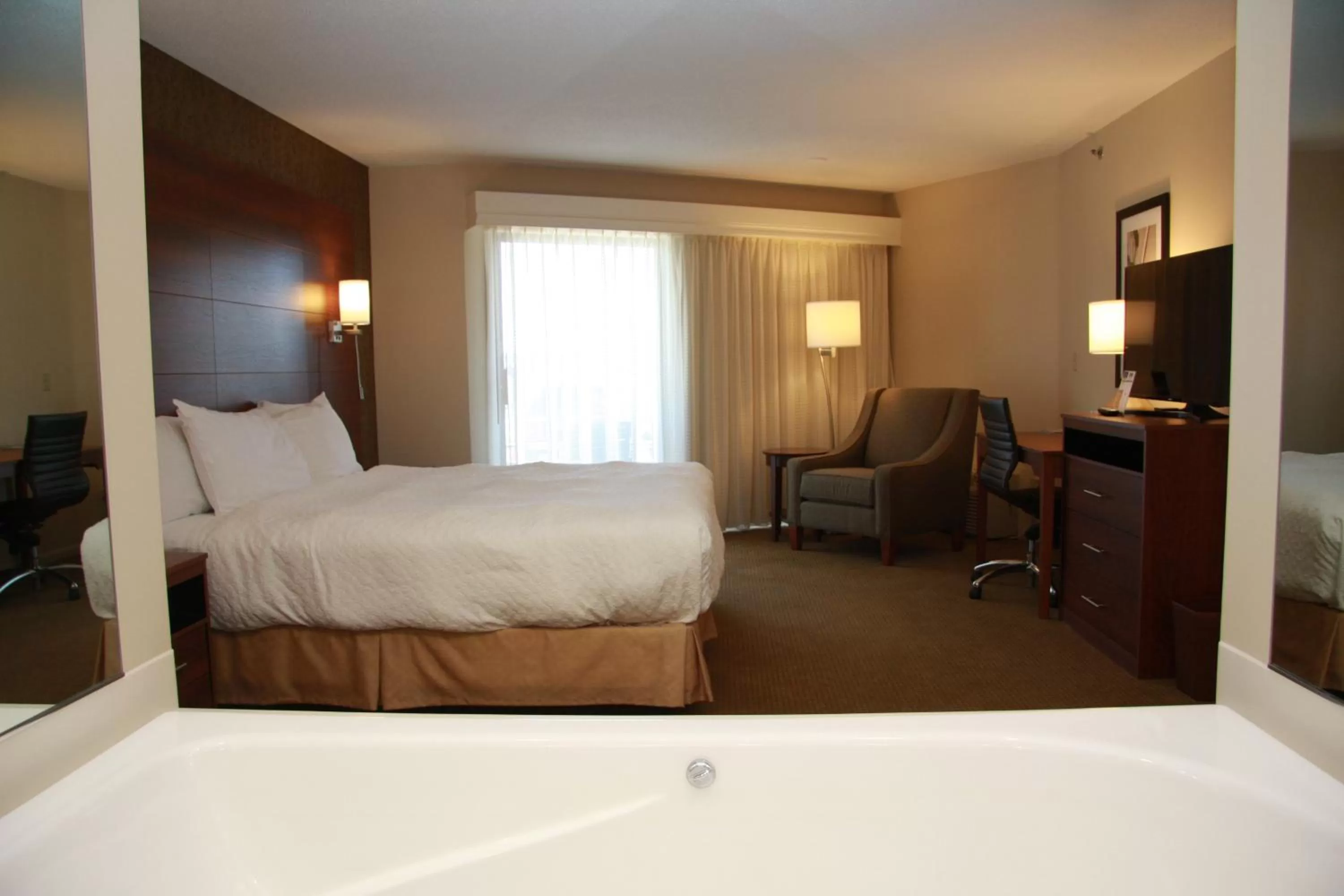 Bed in Budget Host Inn & Suites