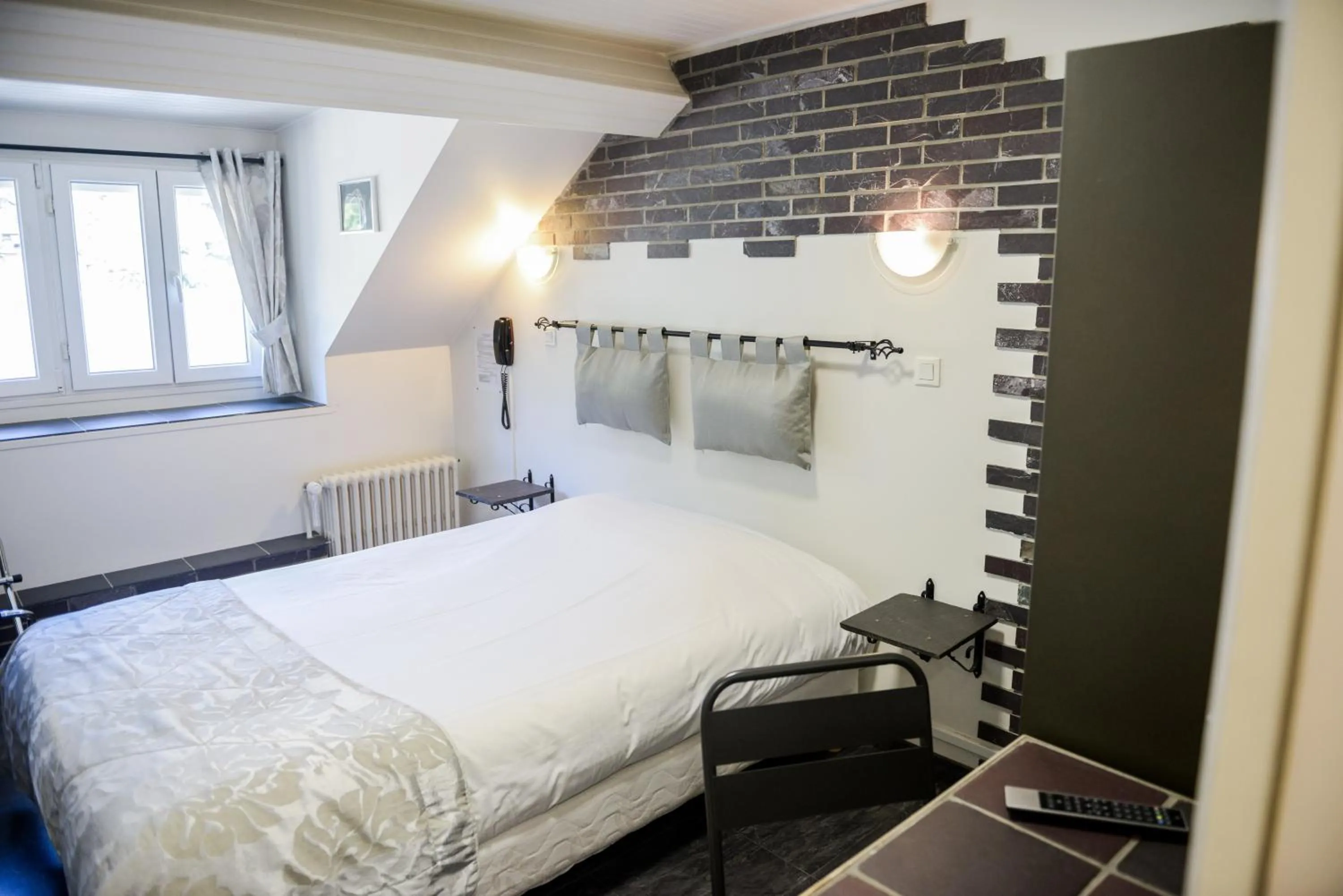 Bed in Logis Le Saint Hubert