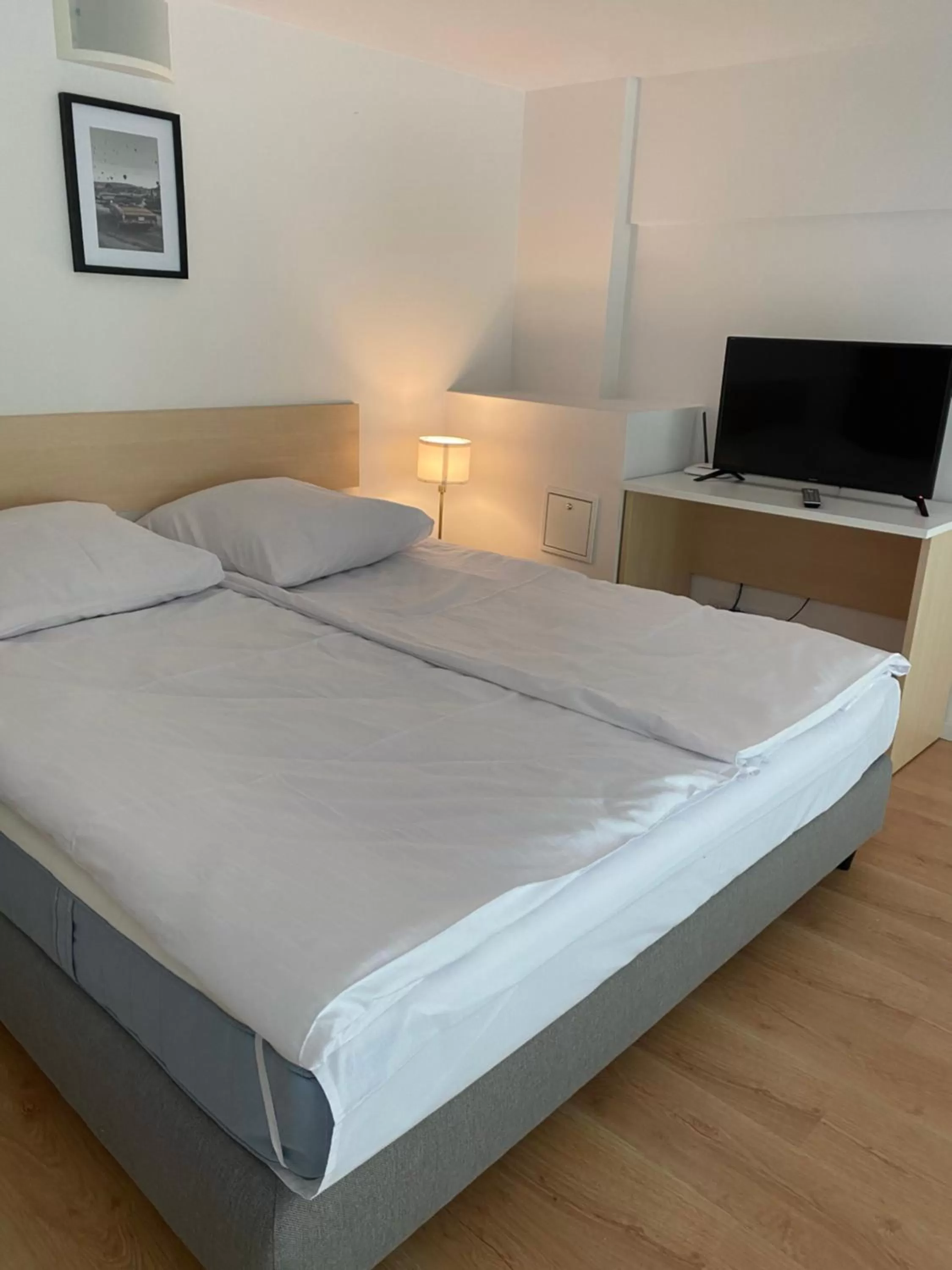 Bed in SleepWell Apartments