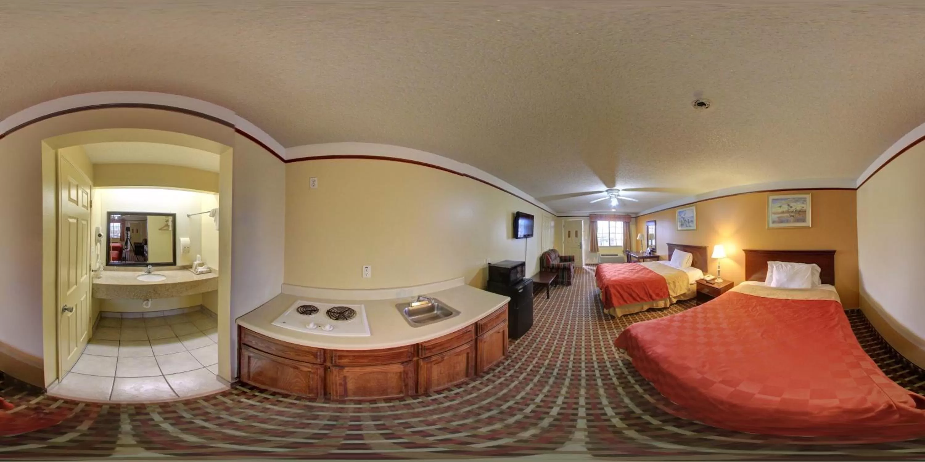 Kitchen or kitchenette, Bed in Deluxe Inn and Suites