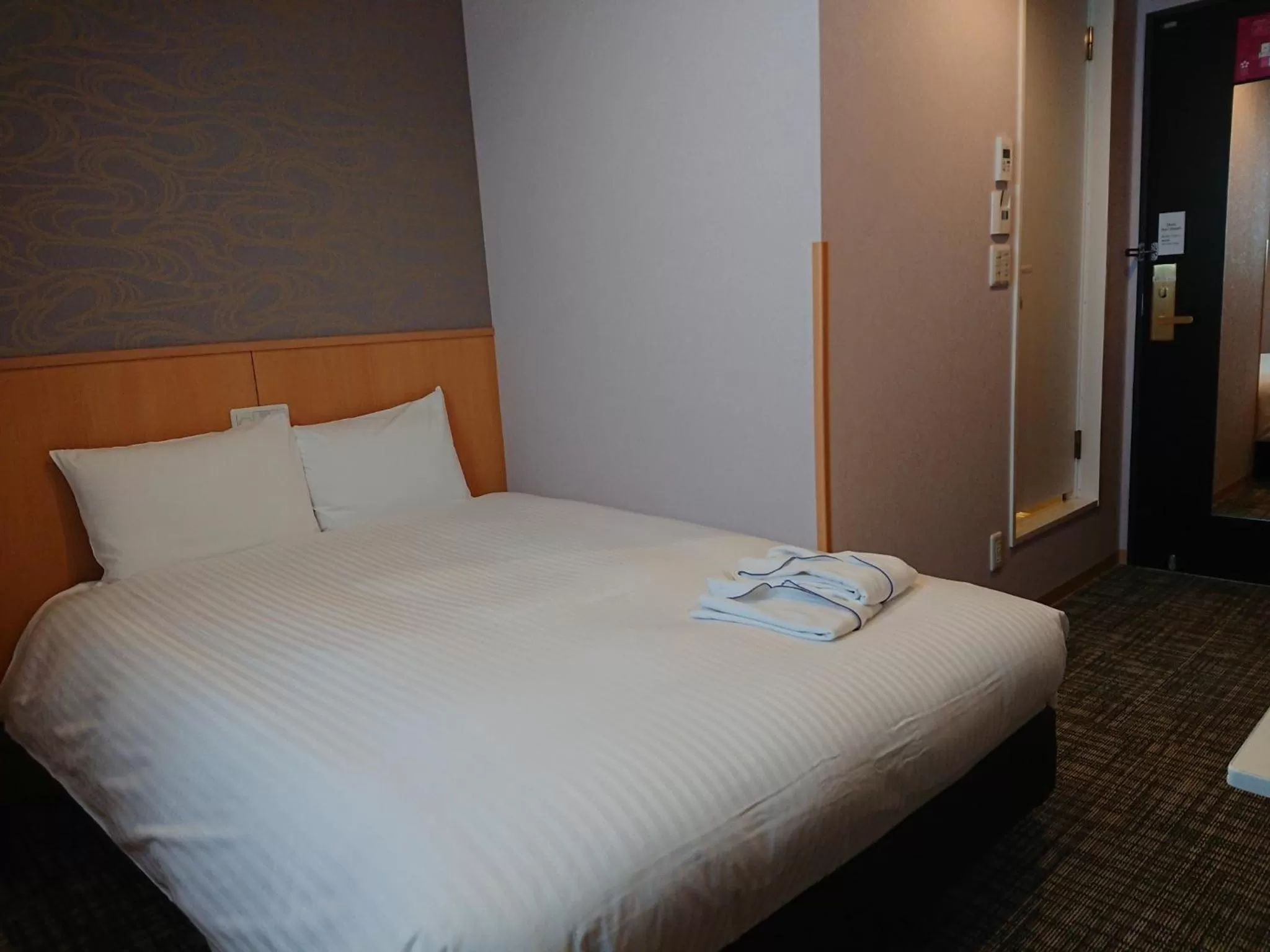 Bed in SAKURA SKY HOTEL KASHIWA(桜スカイホテル柏)