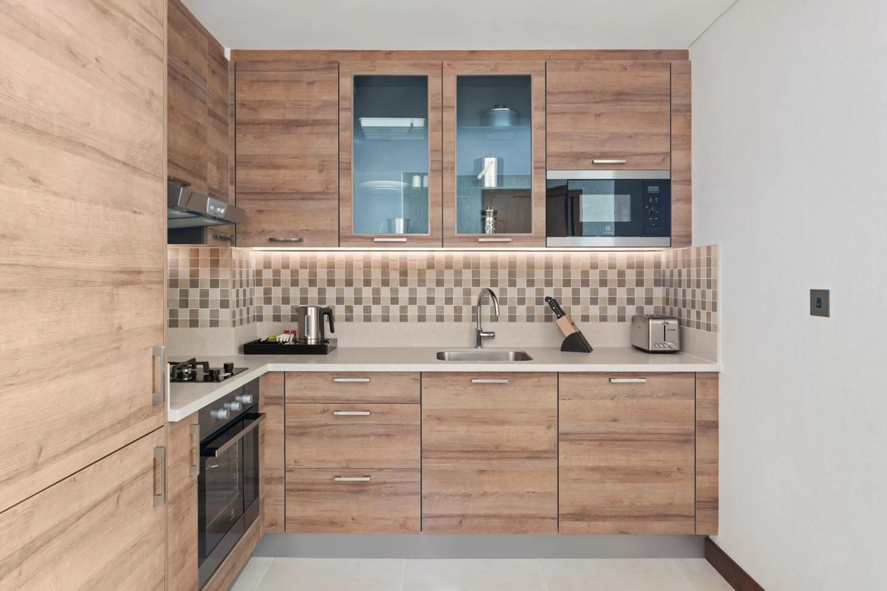 Kitchen or kitchenette in Staybridge Suites Dubai Al-Maktoum Airport by IHG