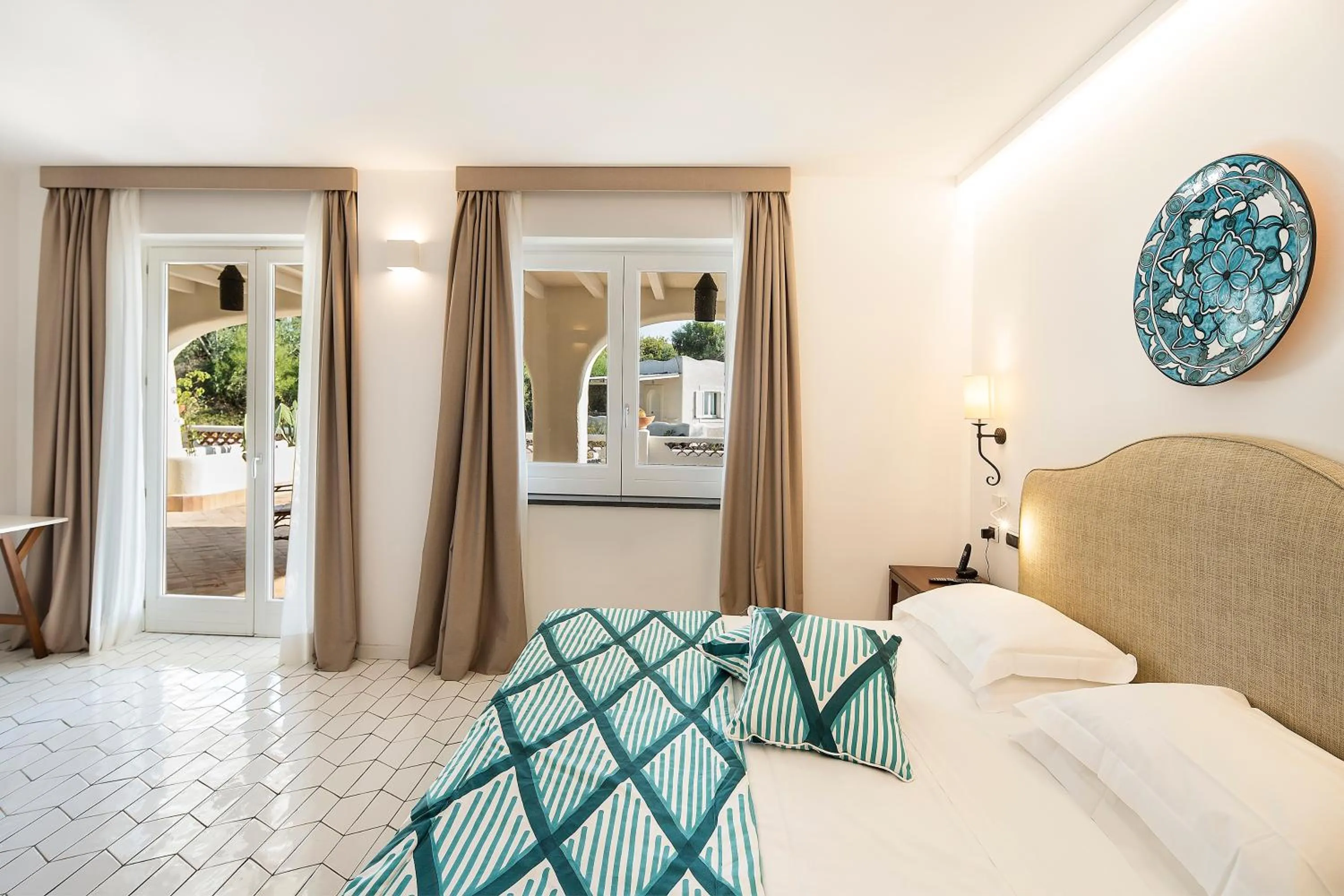 Bed in Therasia Resort Sea and SPA - The Leading Hotels of the World