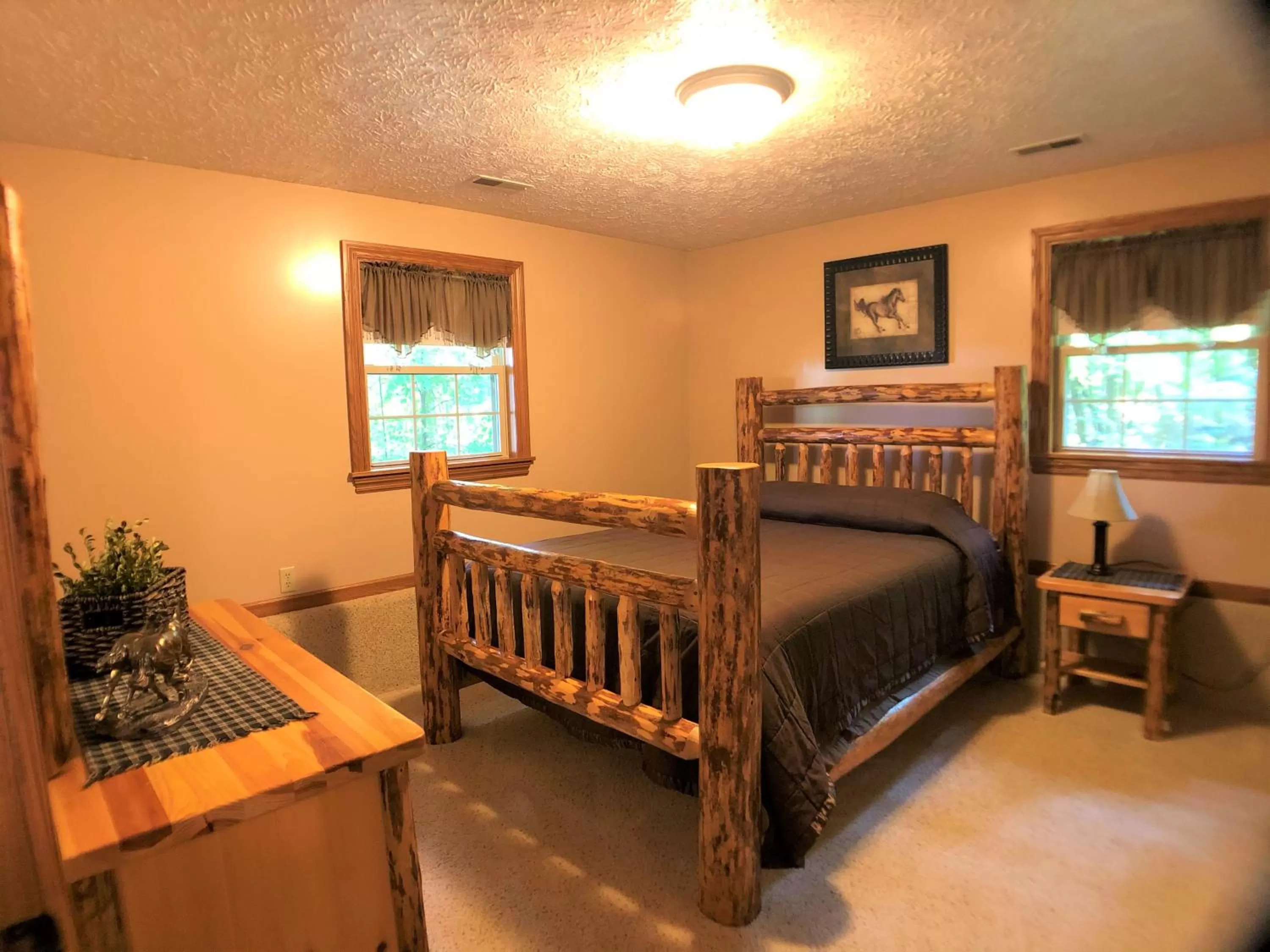 Bed in Sojourner's Lodge & Log Cabin Suites