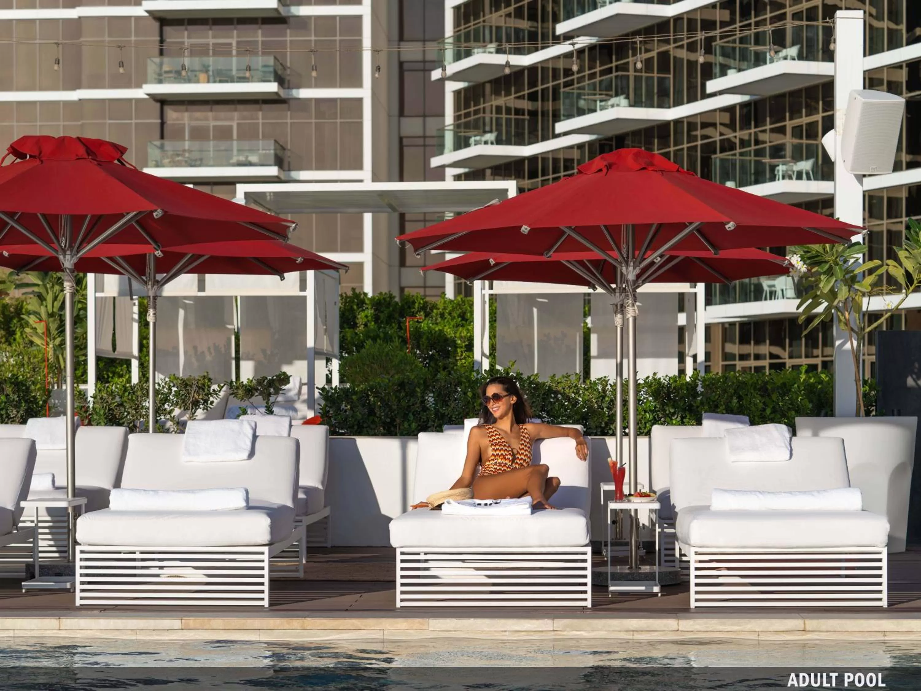 Swimming pool in Th8 Palm Dubai Beach Resort Vignette Collection, an IHG hotel