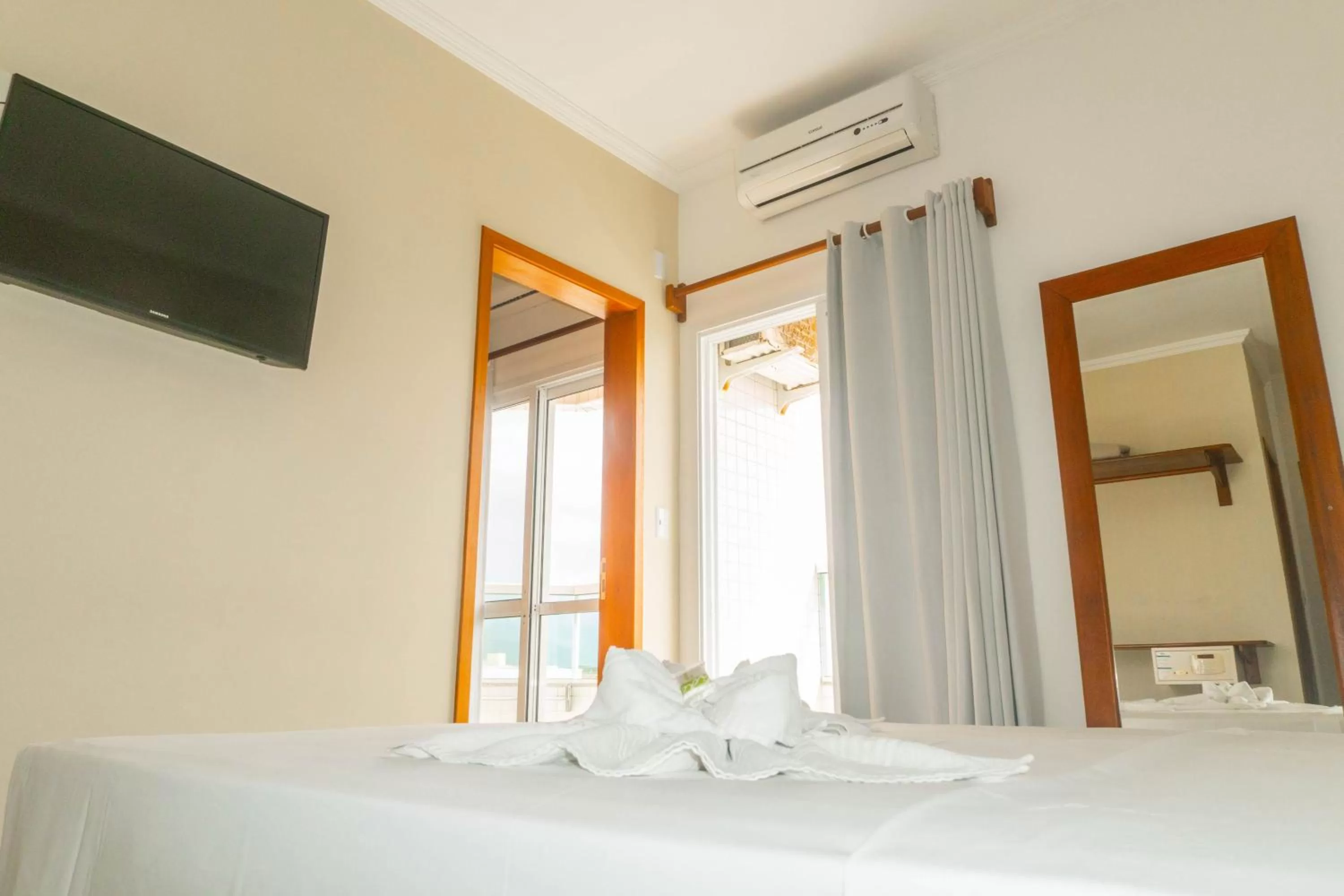 Communal lounge/ TV room, Bed in UPG Hotel