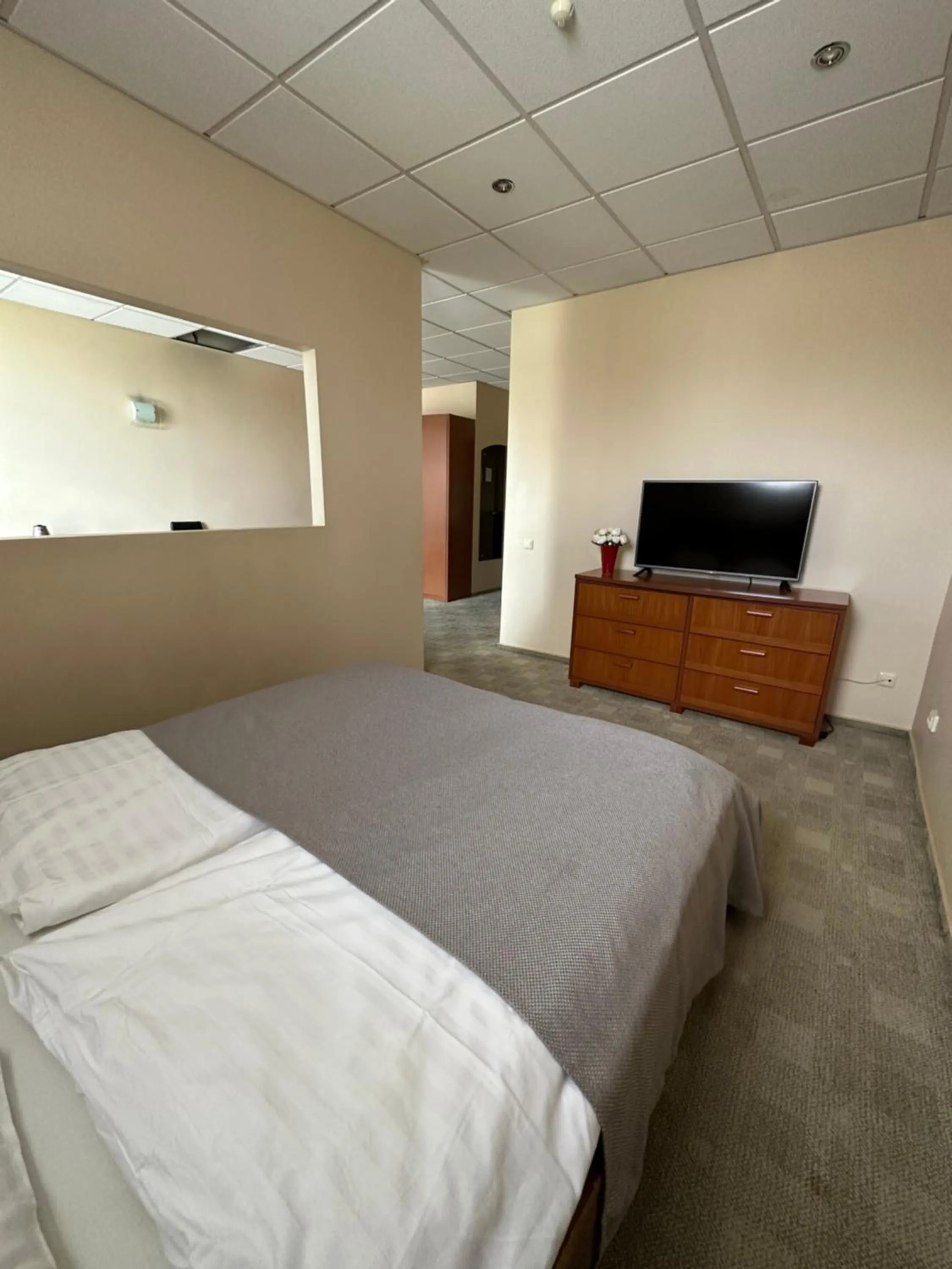 Communal lounge/ TV room, Bed in Riga Unimars Hotel