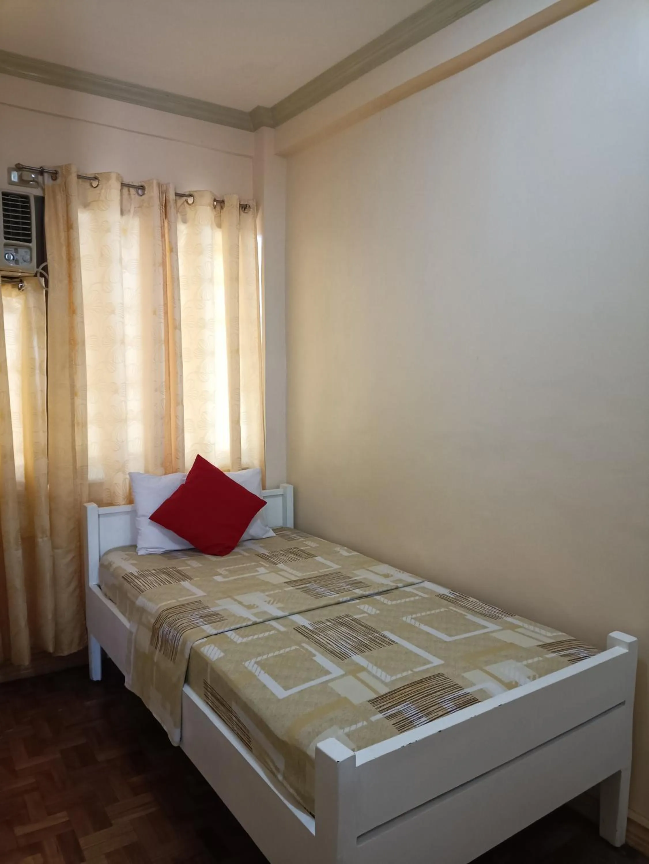 Bed in Golden Belle Apartelle and Suites