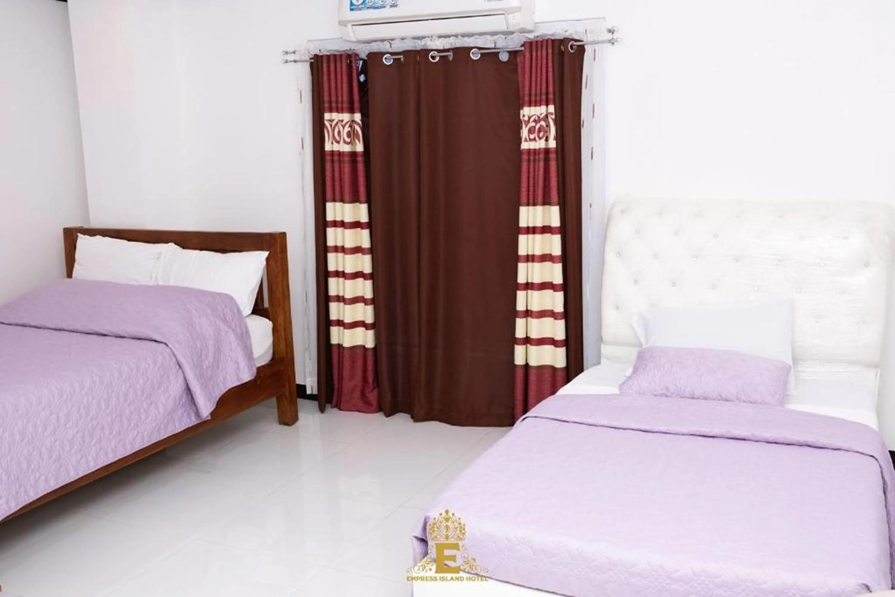 Bed in Empress Island Hotel