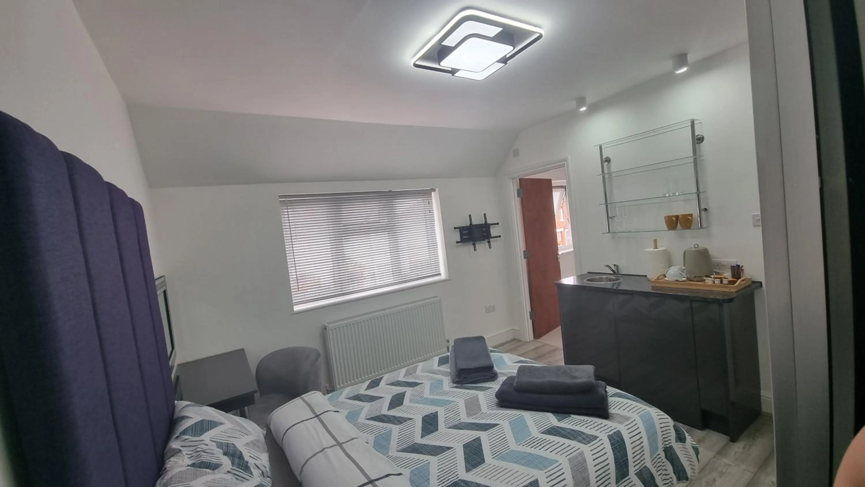 Bed in Stylish Suites with kitchenette