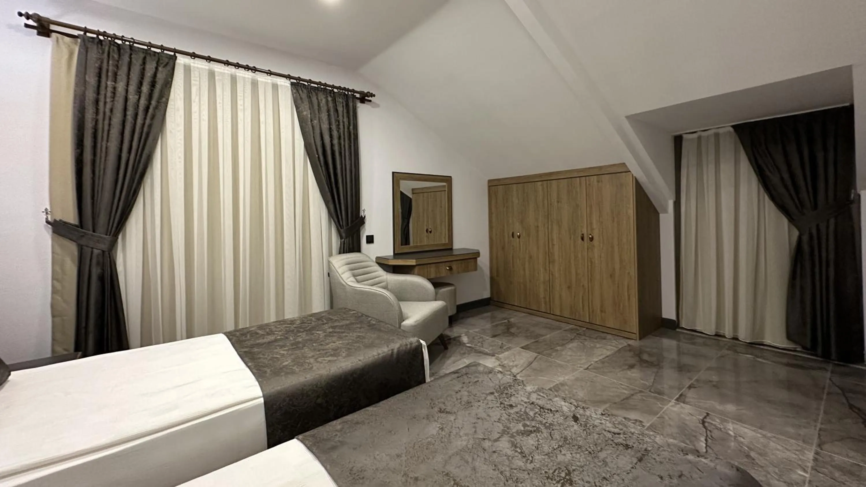 Bed in Quality Gold Suite Hotel