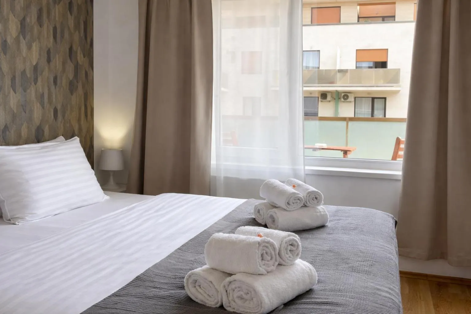 Bed in Corvin Center Suites