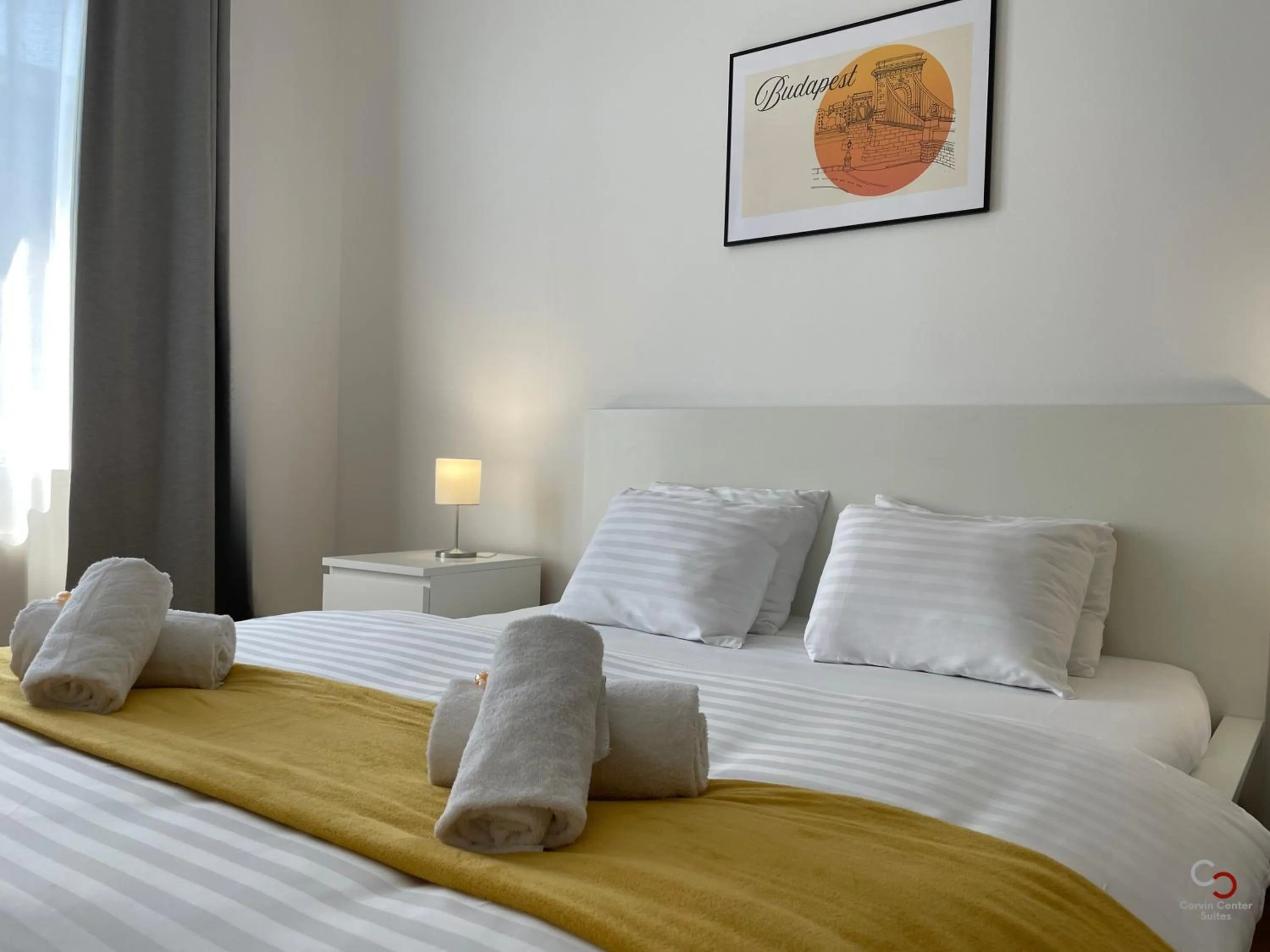 Bed in Corvin Center Suites