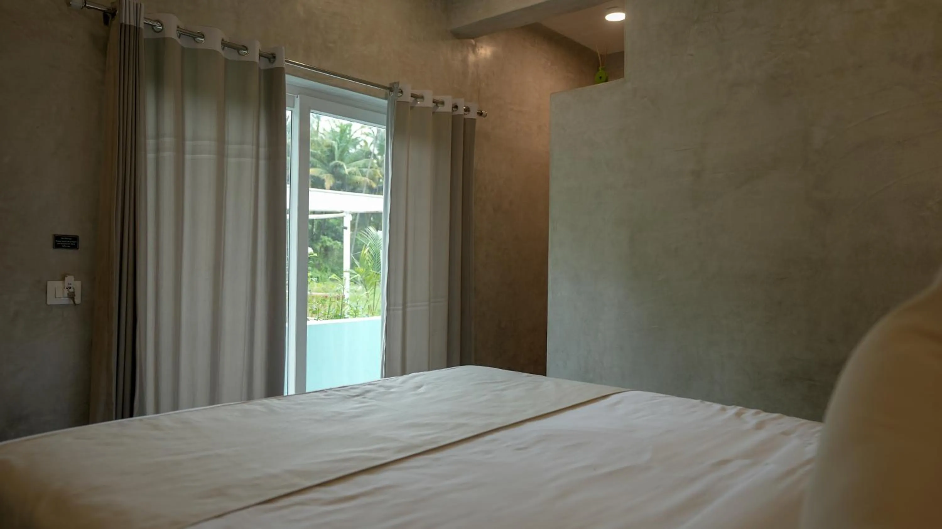 Bed in Whiteflower Resort Morjim