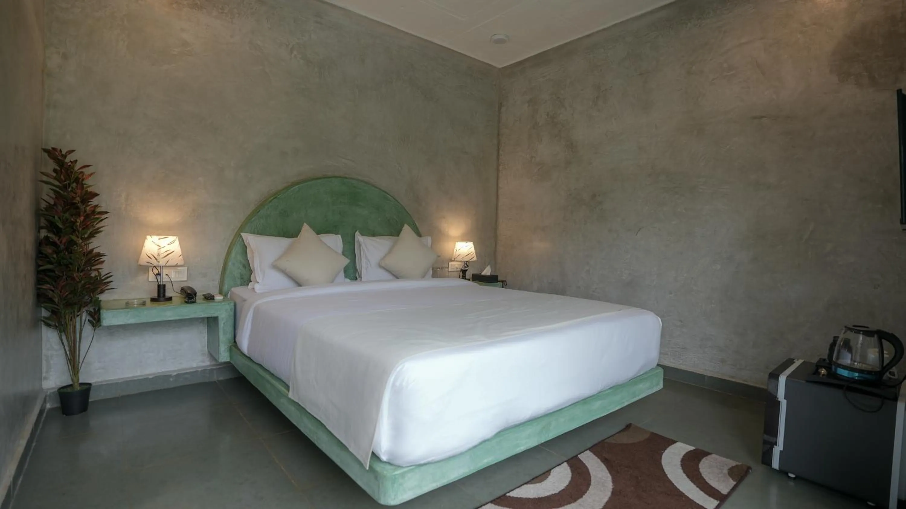 Bed in Whiteflower Resort Morjim