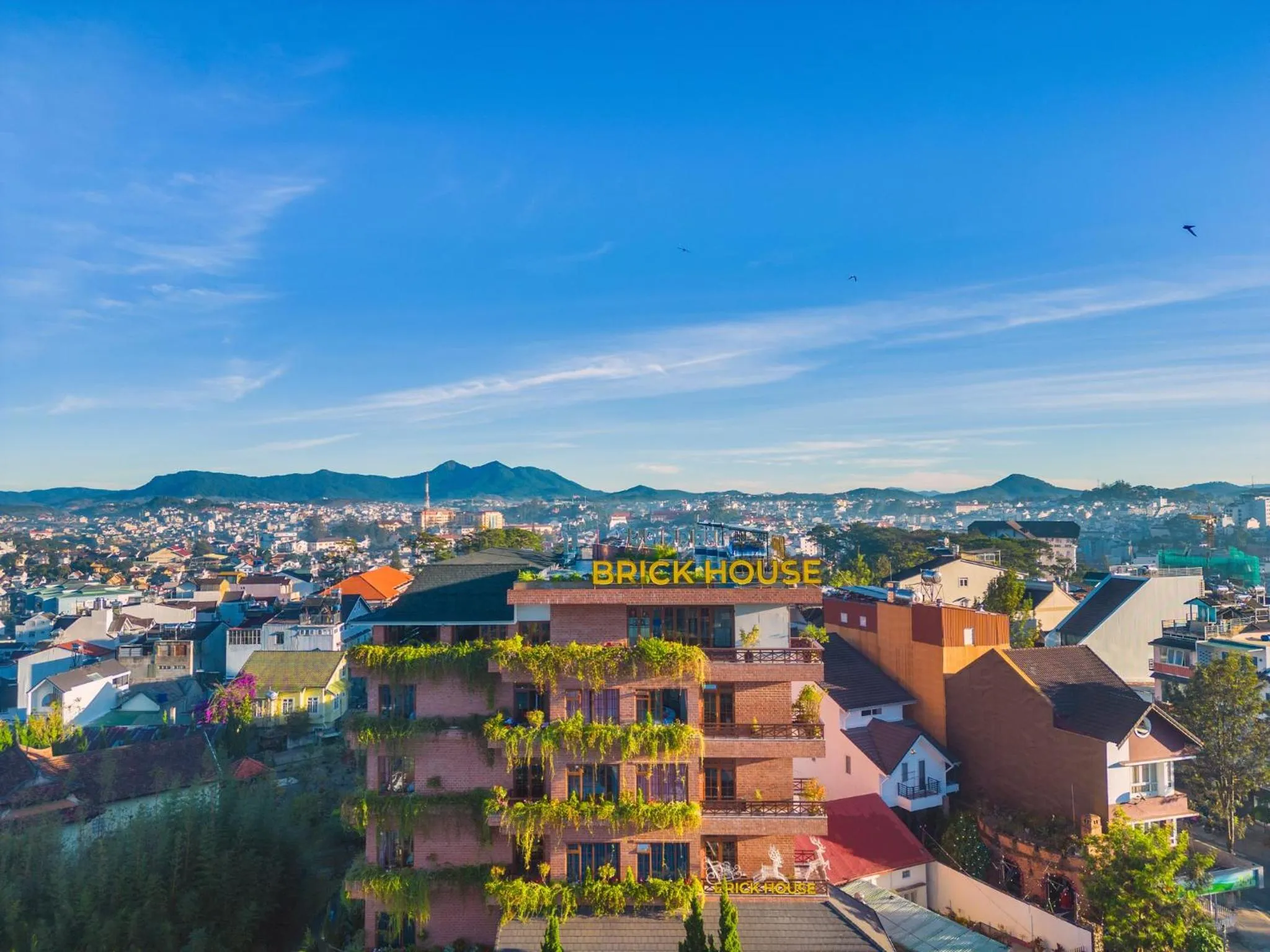 Property logo or sign in Brick House Dalat Hotel