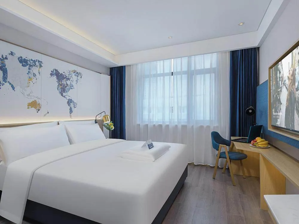 Bed in Kyriad Marvelous Hotel Weihai Happy Gate Weigao Plaza