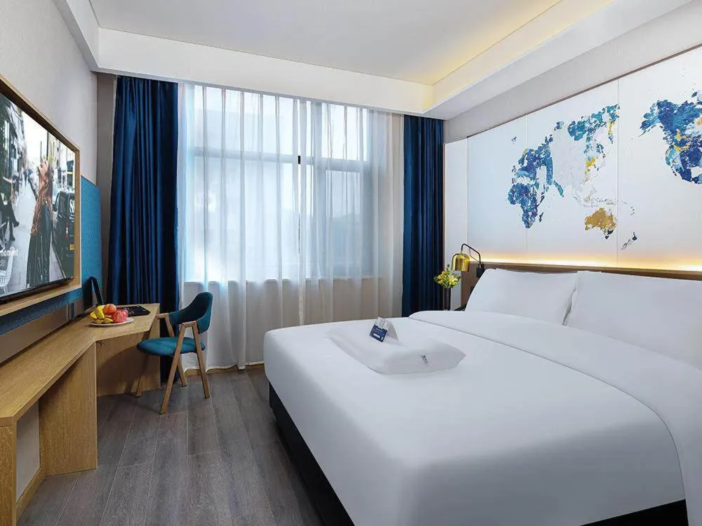 Bed in Kyriad Marvelous Hotel Weihai Happy Gate Weigao Plaza