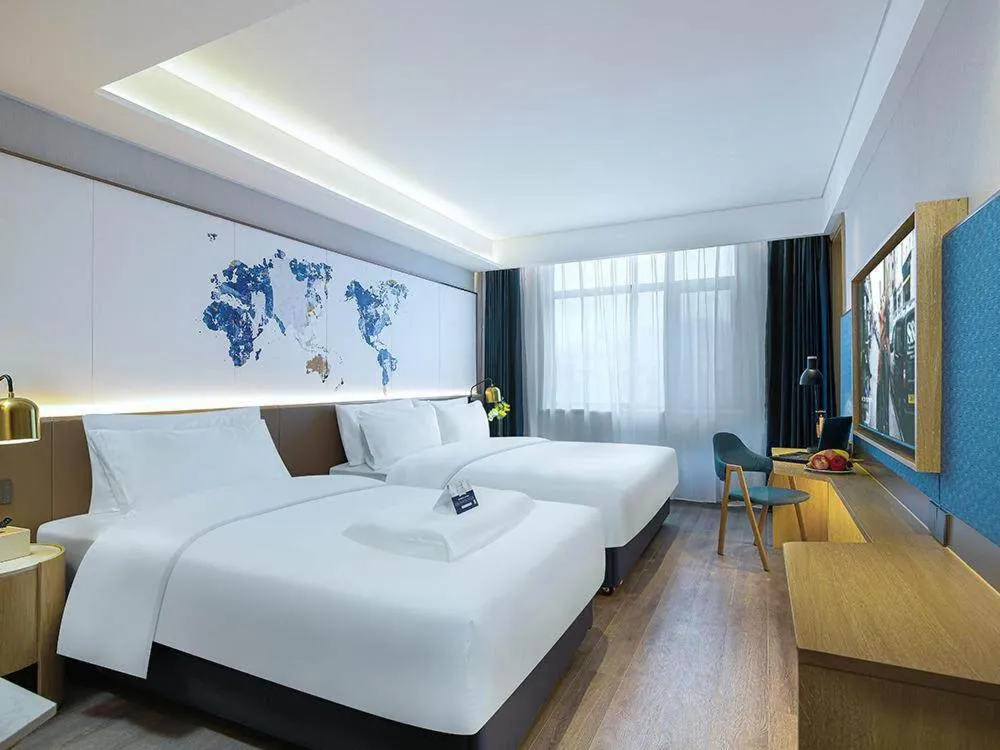 Bed in Kyriad Marvelous Hotel Weihai Happy Gate Weigao Plaza